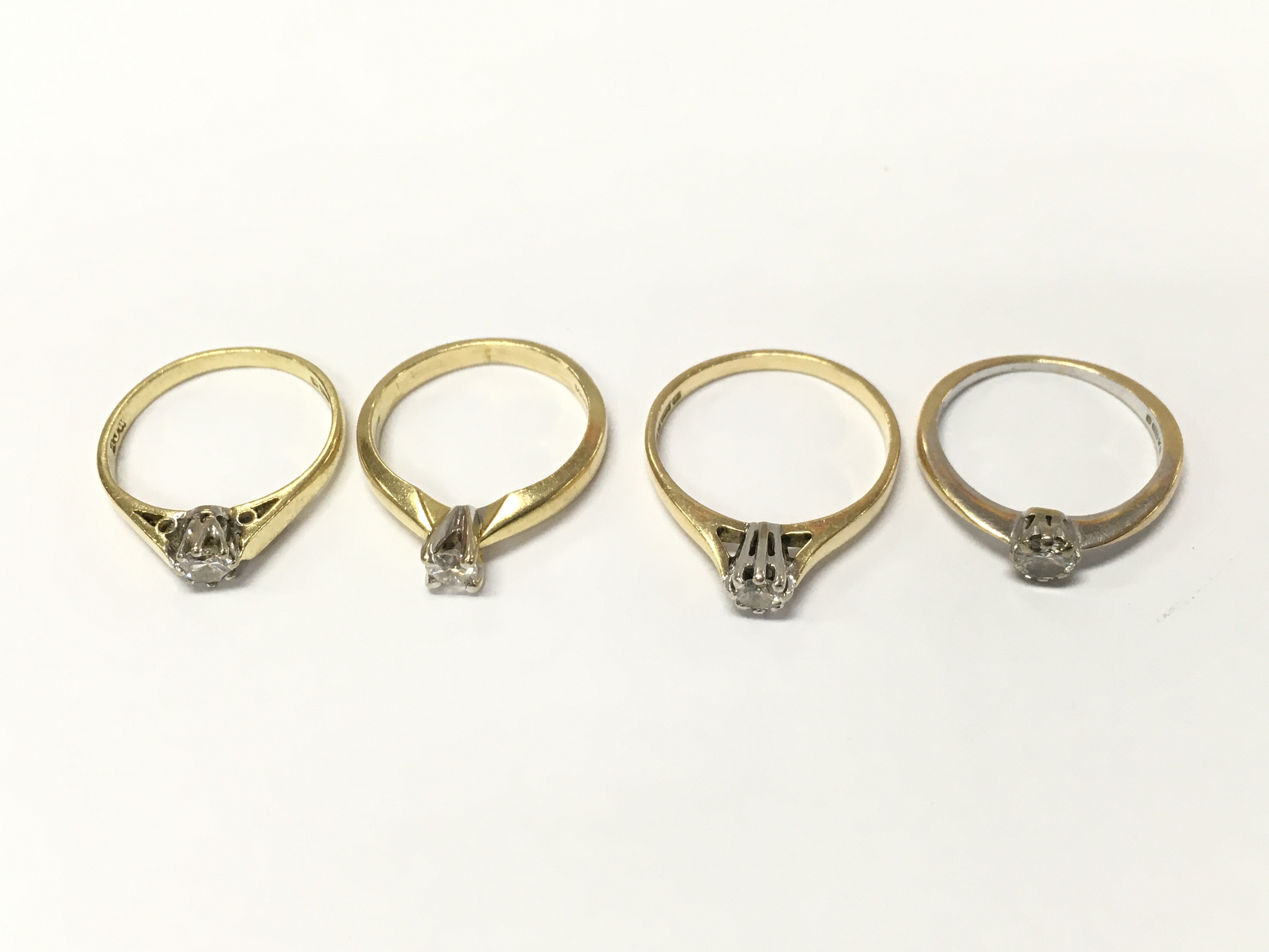 Four 18ct gold diamond solitaire rings sizes I 1/2 K and L approximately 8.7g