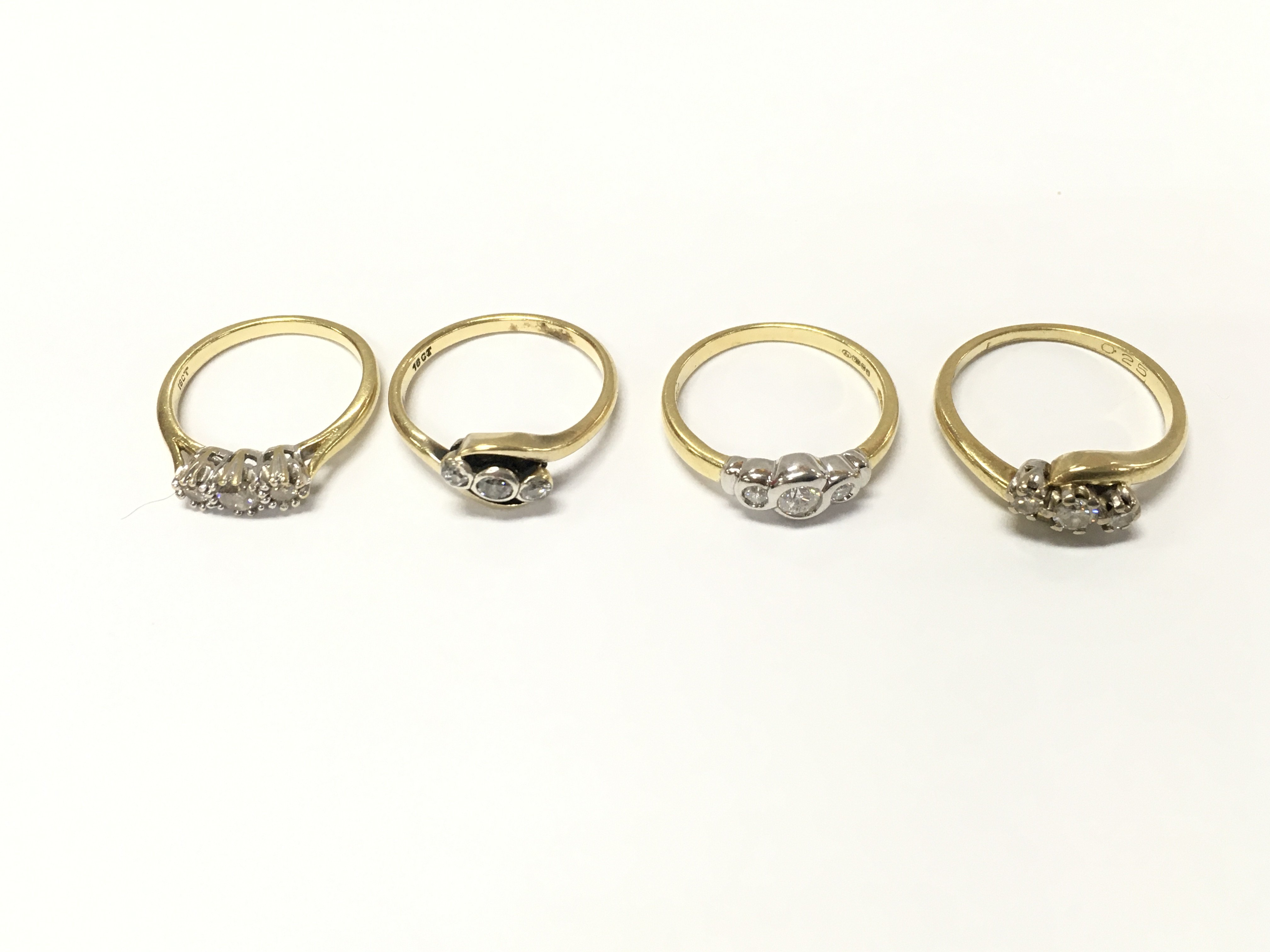 Four 18ct gold diamond three stone rings sizes K N N1/2 approximately 11.7g