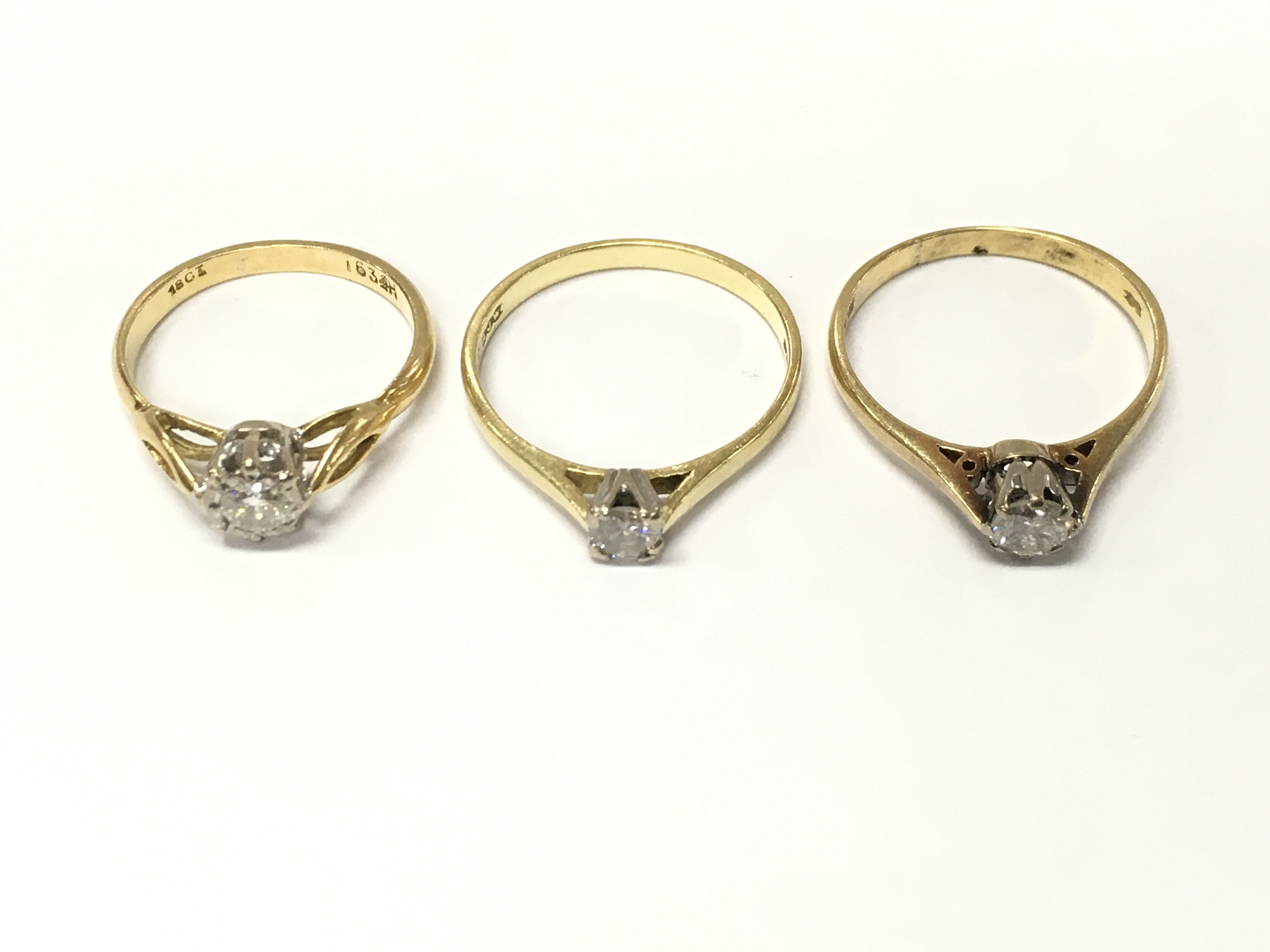 Three 18ct gold diamond solitaire rings. Size K and N approximately 6.5g