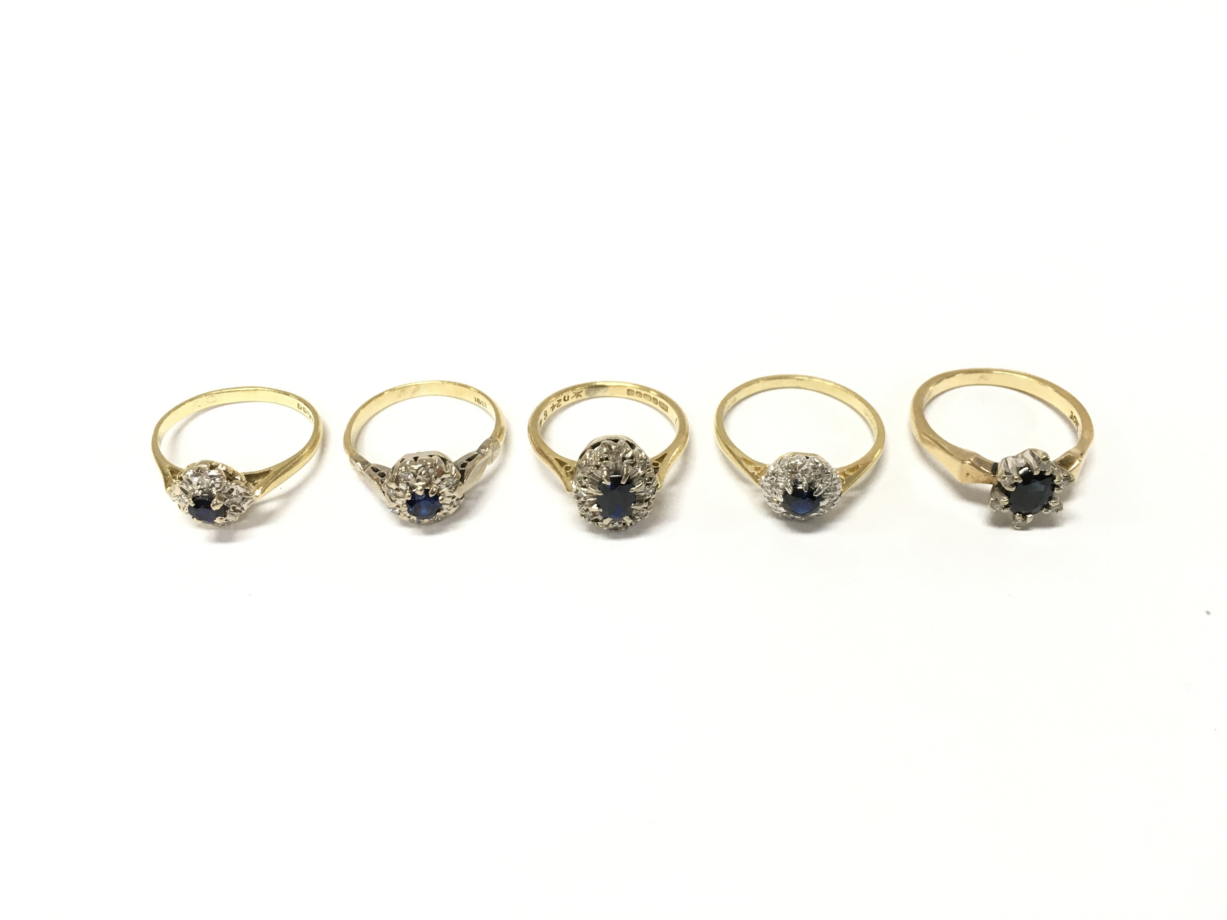 Five 18ct gold diamond and sapphire cluster rings. Size J K and N approximately 16g