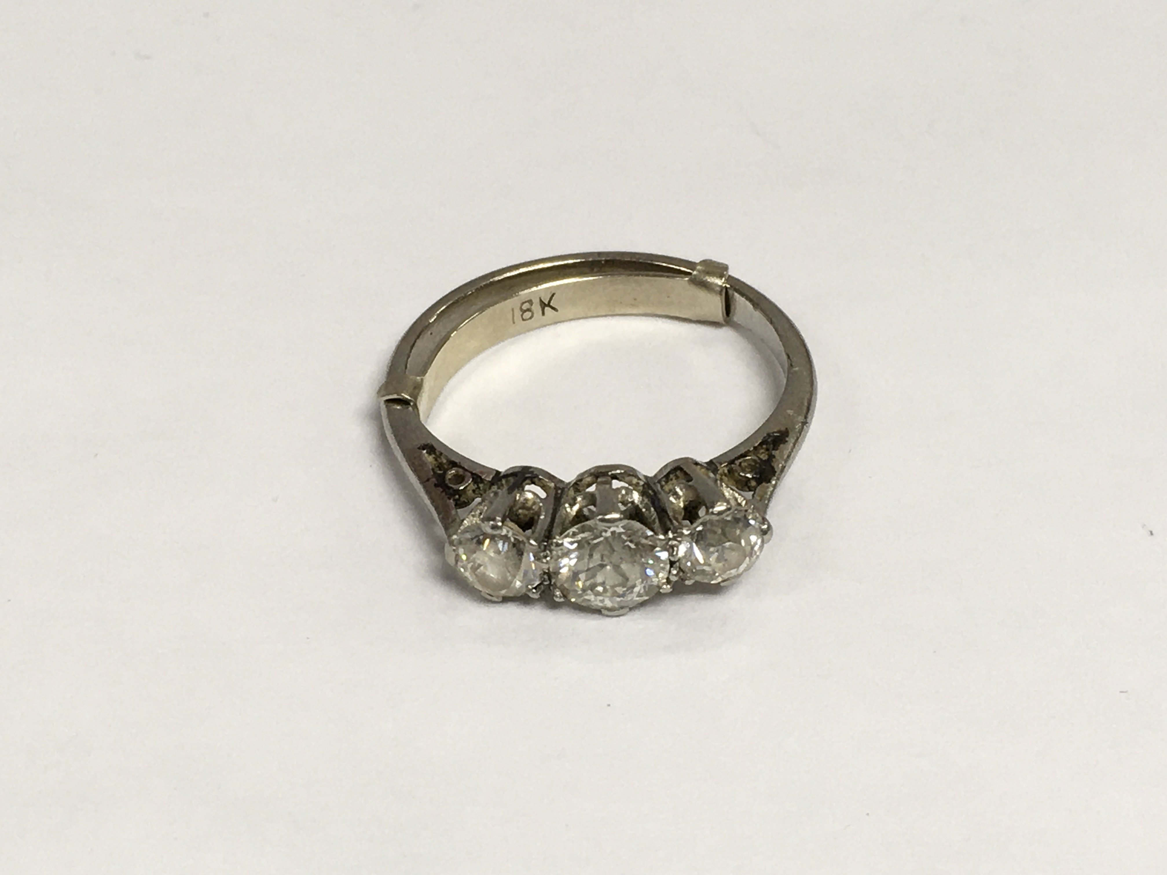 A 1940s platinum three stone diamond ring, approx 3g and approx size H. Shipping category A.
