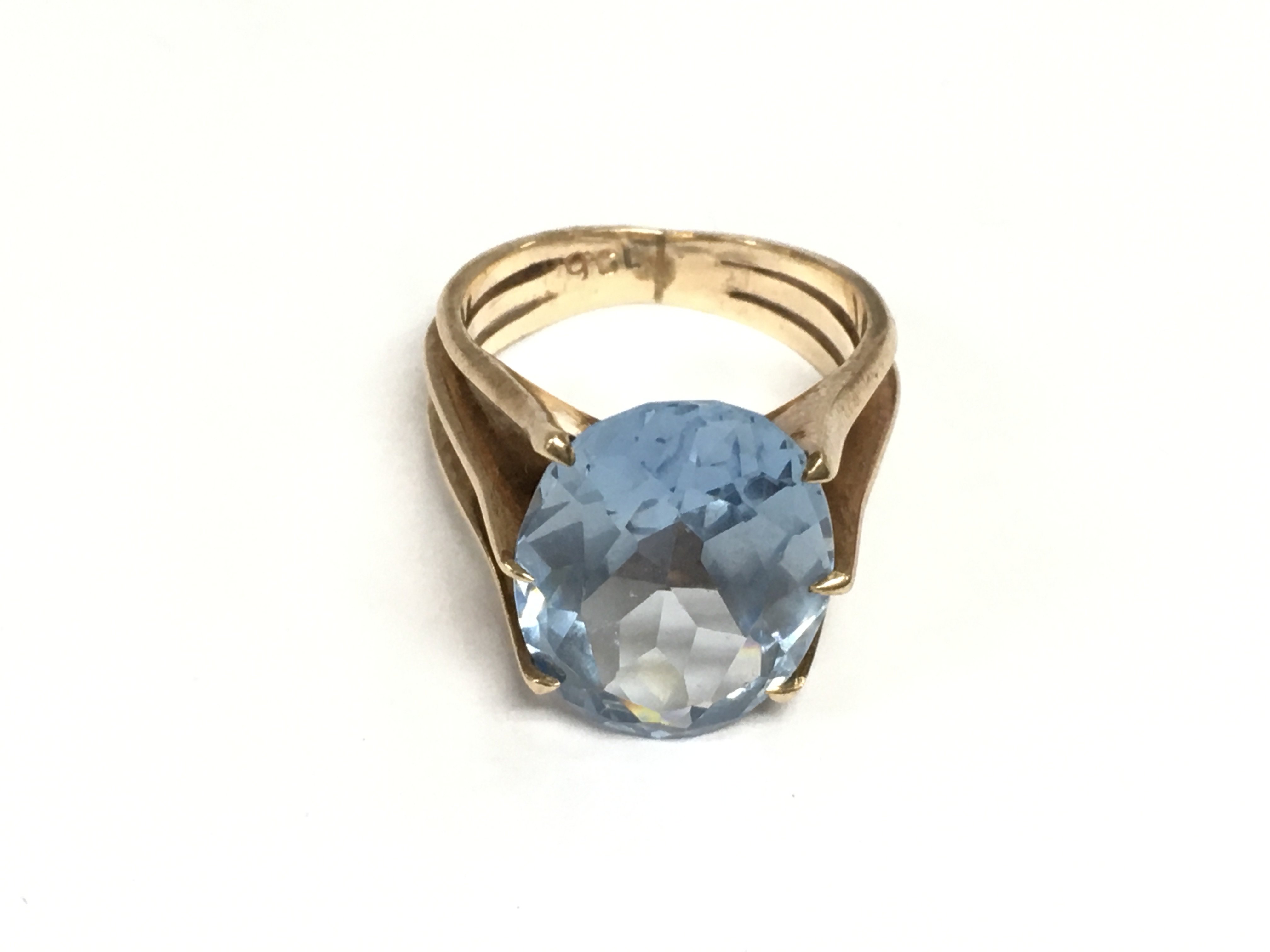 A 9ct rose gold ring set with a large blue zircon, approx 6.8g and approx size L. Shipping category A.