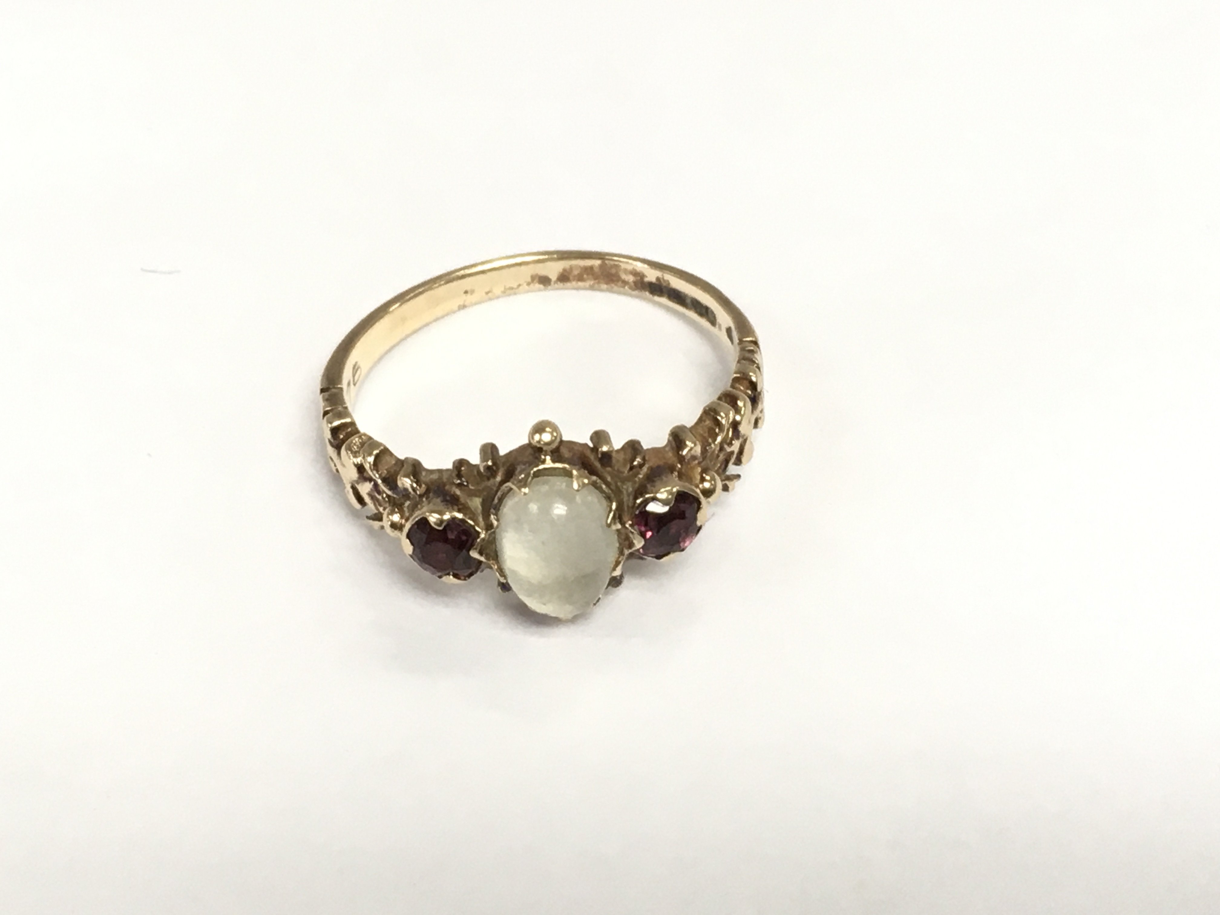 An antique 9ct gold moonstone and garnet ring, approx 2.4g and approx size M-N. Shipping category A.