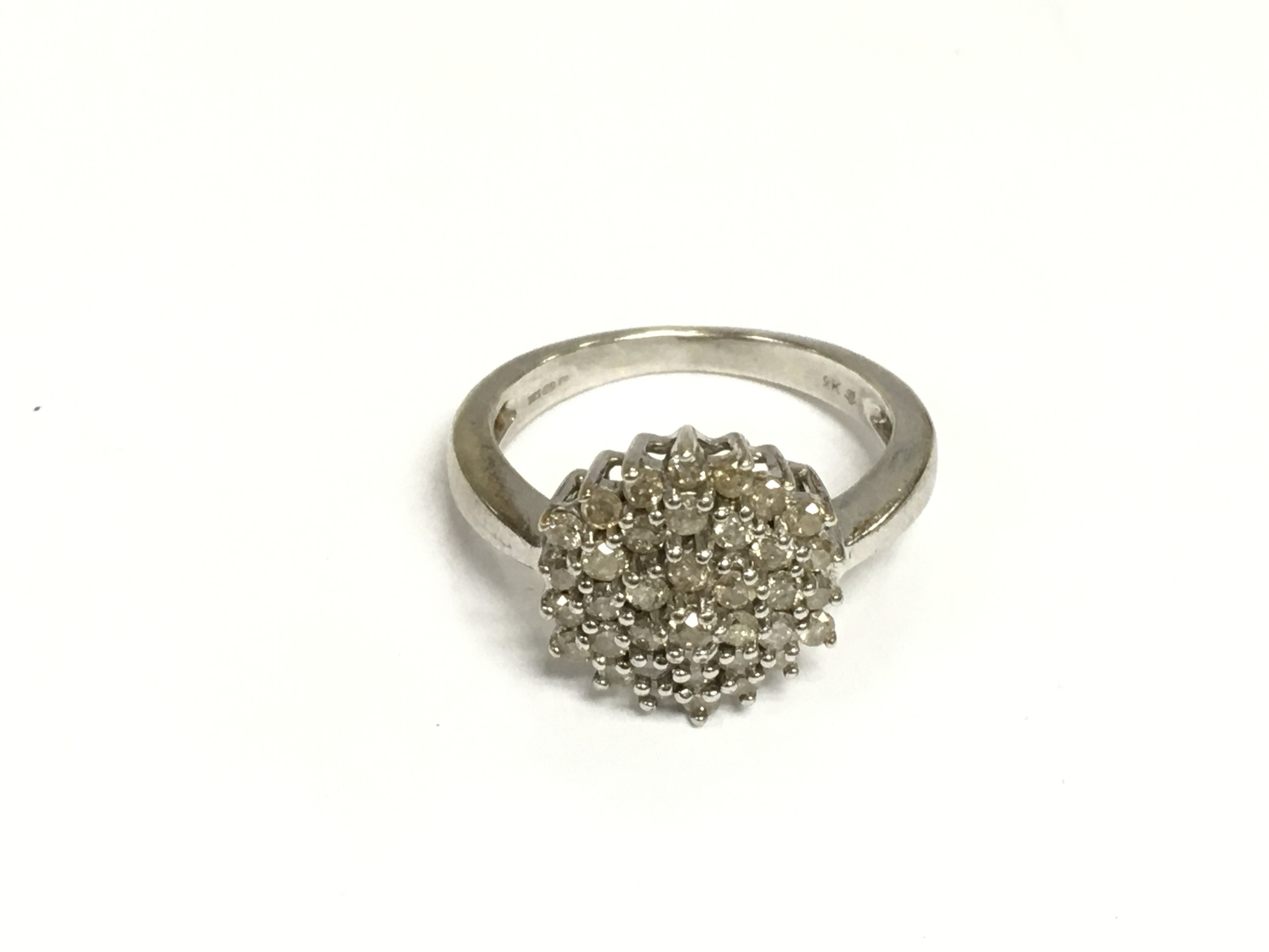 A 9ct white gold diamond cluster ring, approx 5.3g and approx size P-Q. Shipping category A.
