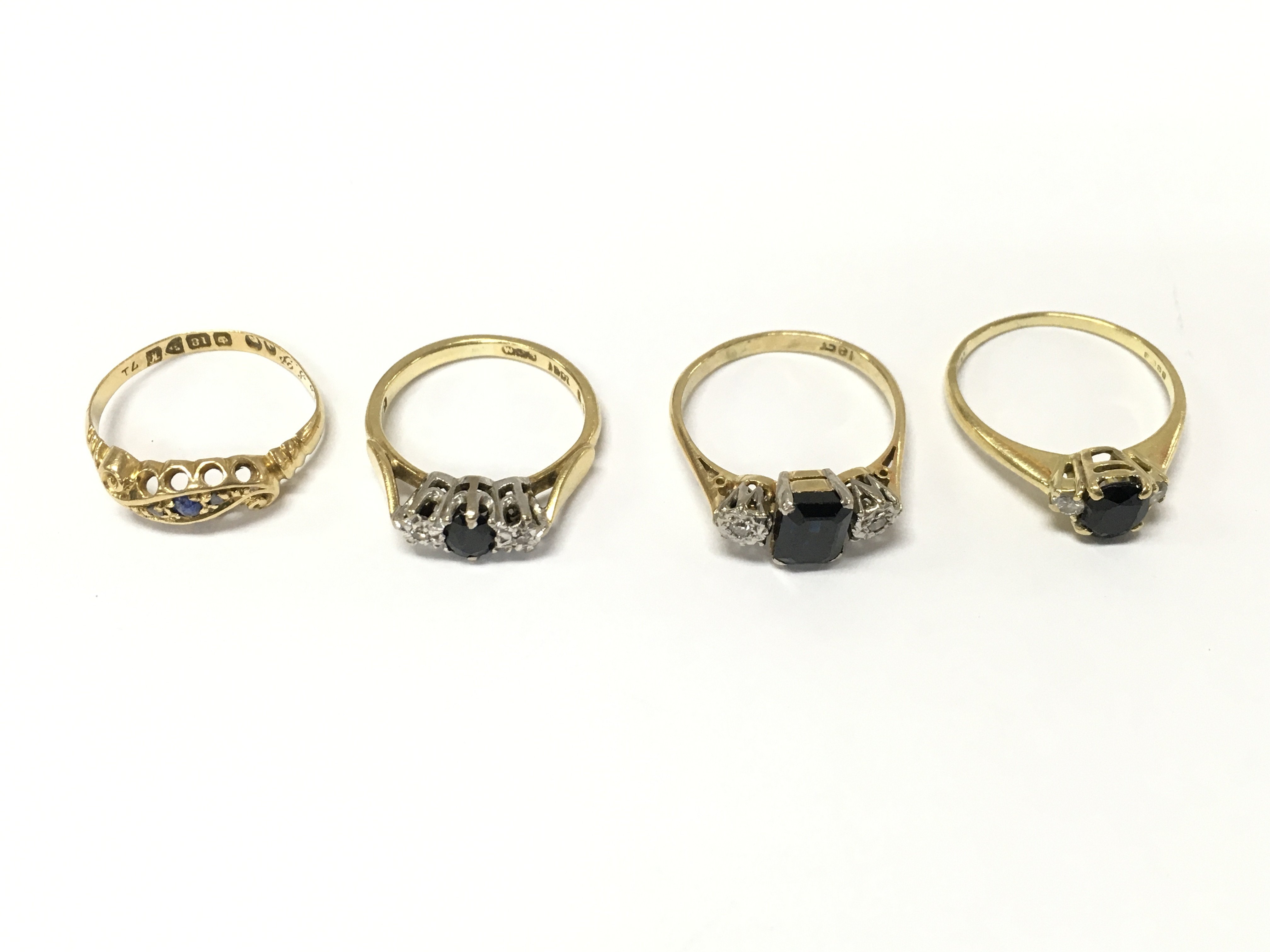 Four 18ct gold diamond and sapphire rings. Size I K L approximately 9.7g