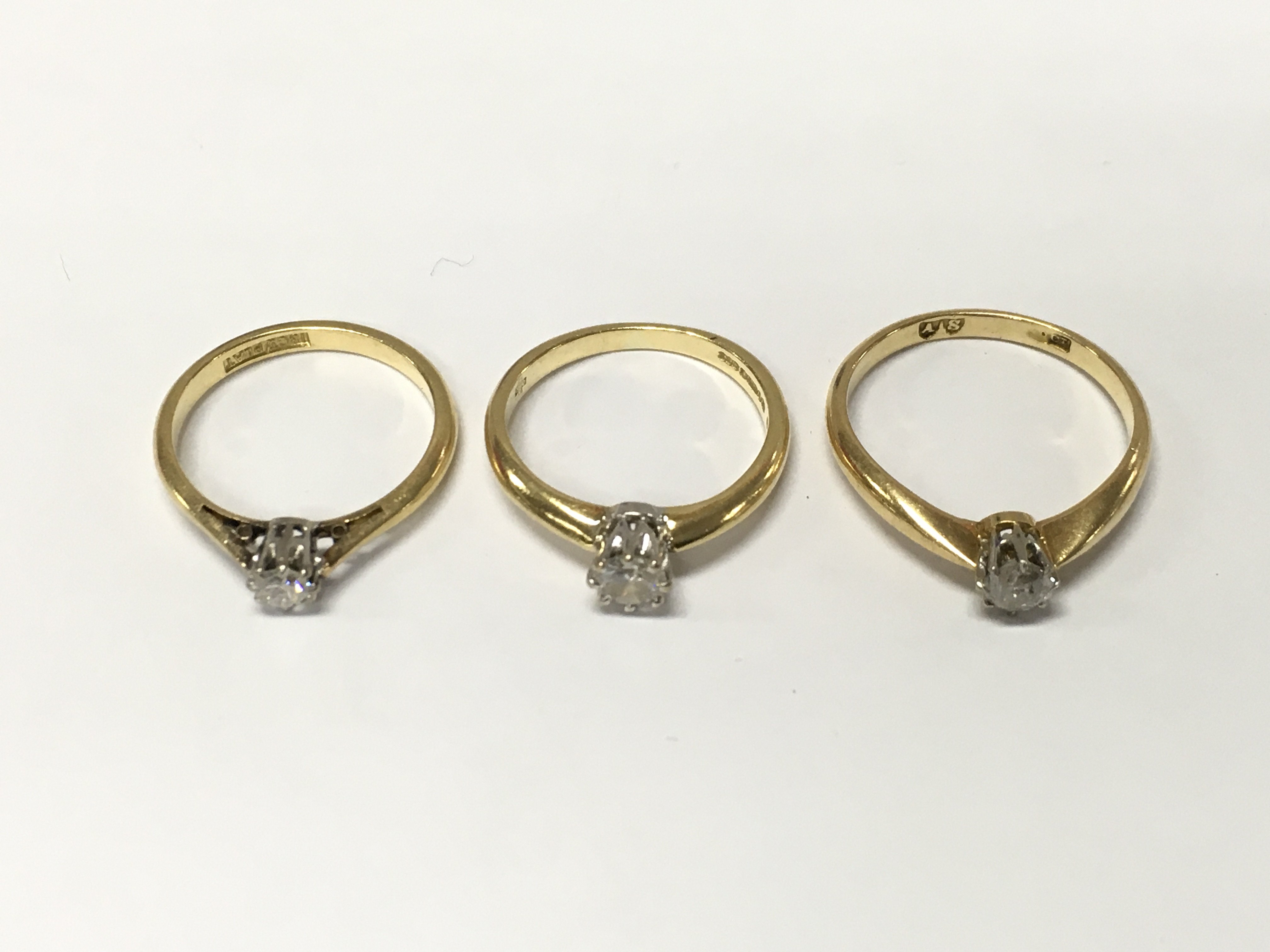 Three 18ct gold diamond solitaire rings. L and O approximately 7.8g