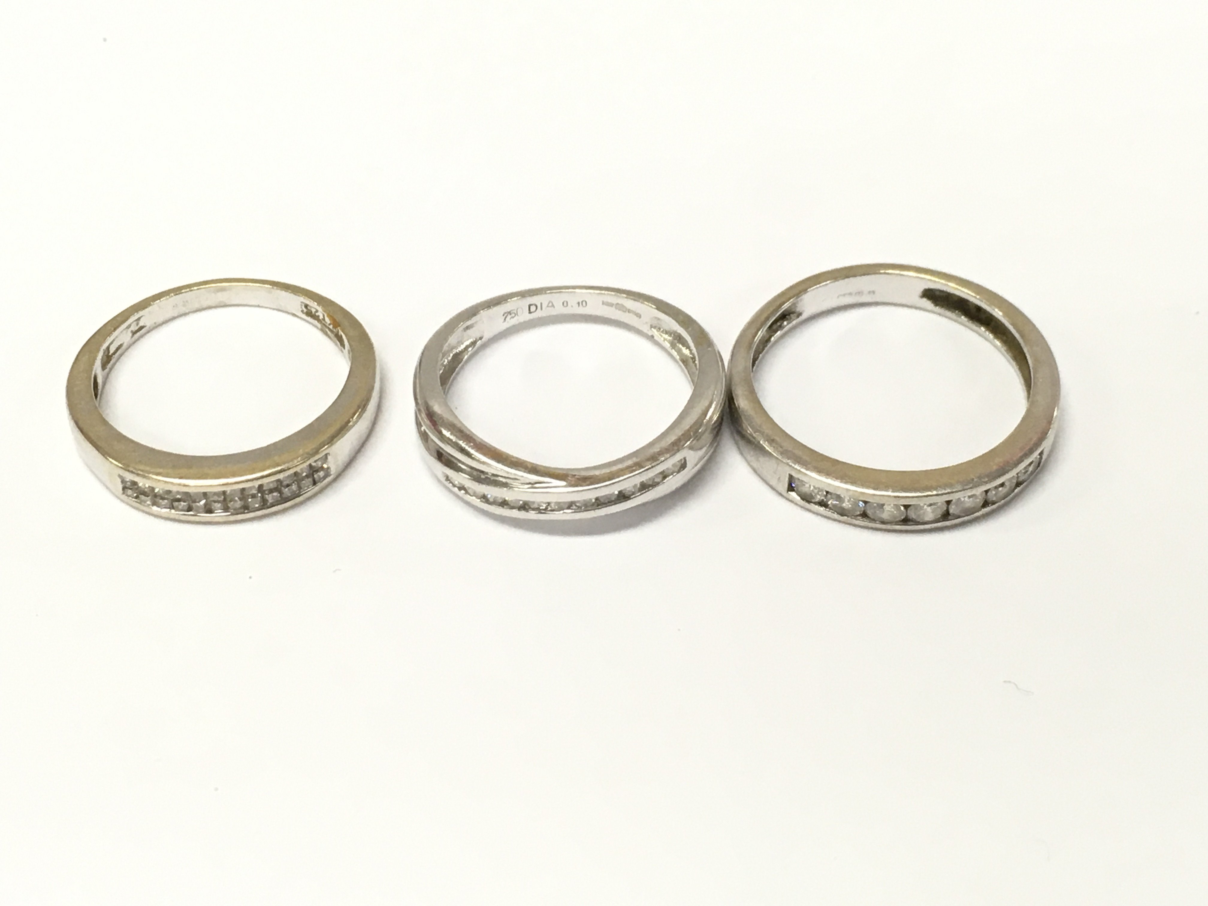 Three 18ct white gold 1/2 hoop diamond rings. Size J M approximately 8.3g