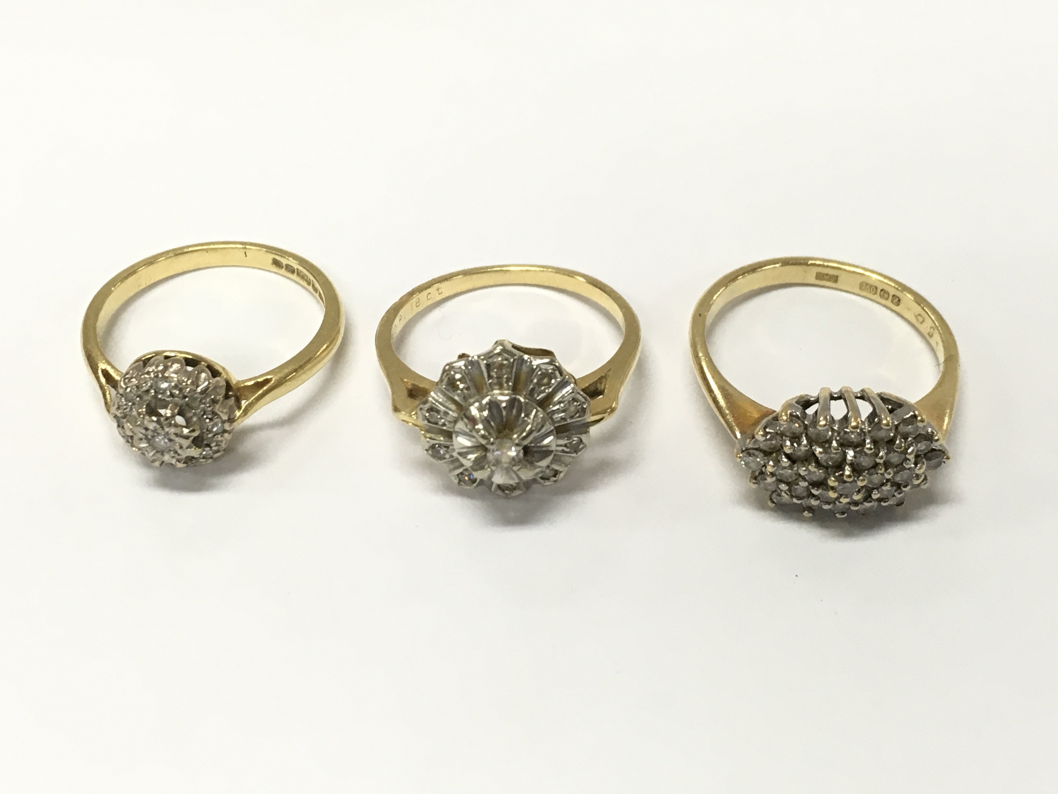 Three 18ct gold diamond cluster rings. Sizes K L1/2 approximately 9.6g