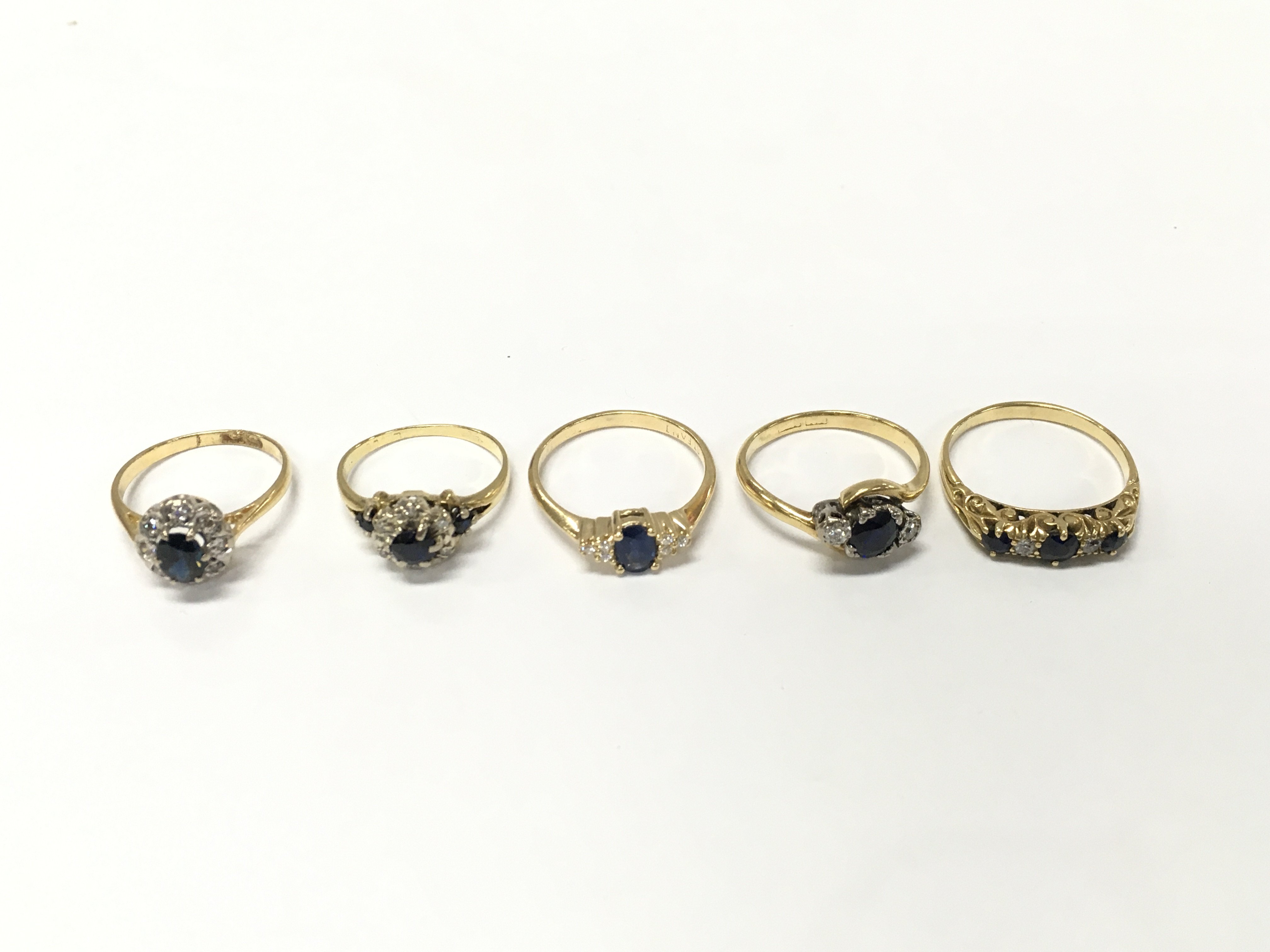 Five unmarked yellow metal diamond and sapphire rings. Sizes K K1/2 M N P approximately 14.7g