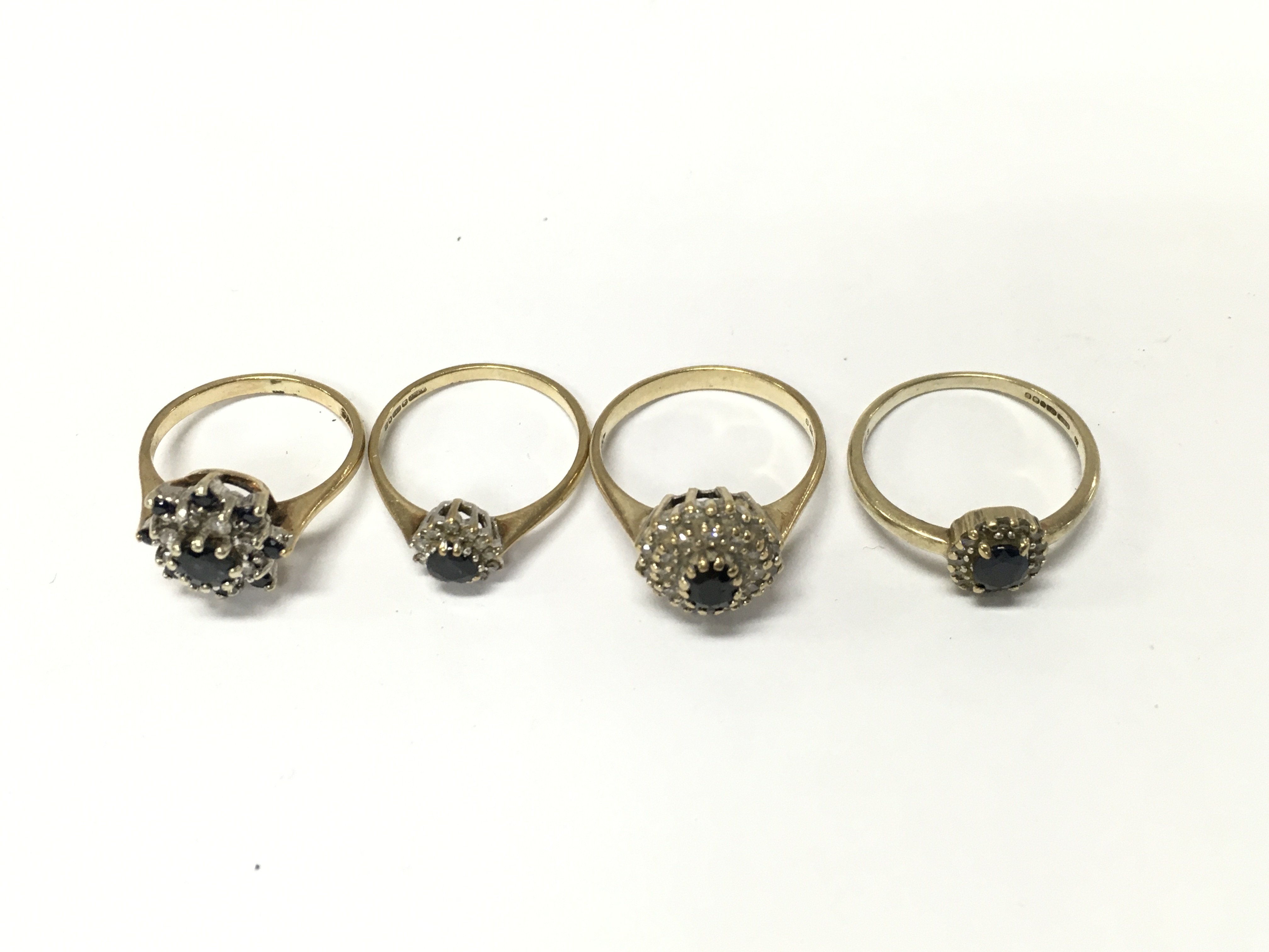 Four 9ct diamond and sapphire cluster rings. Sizes J L1/2 N approximately 9g