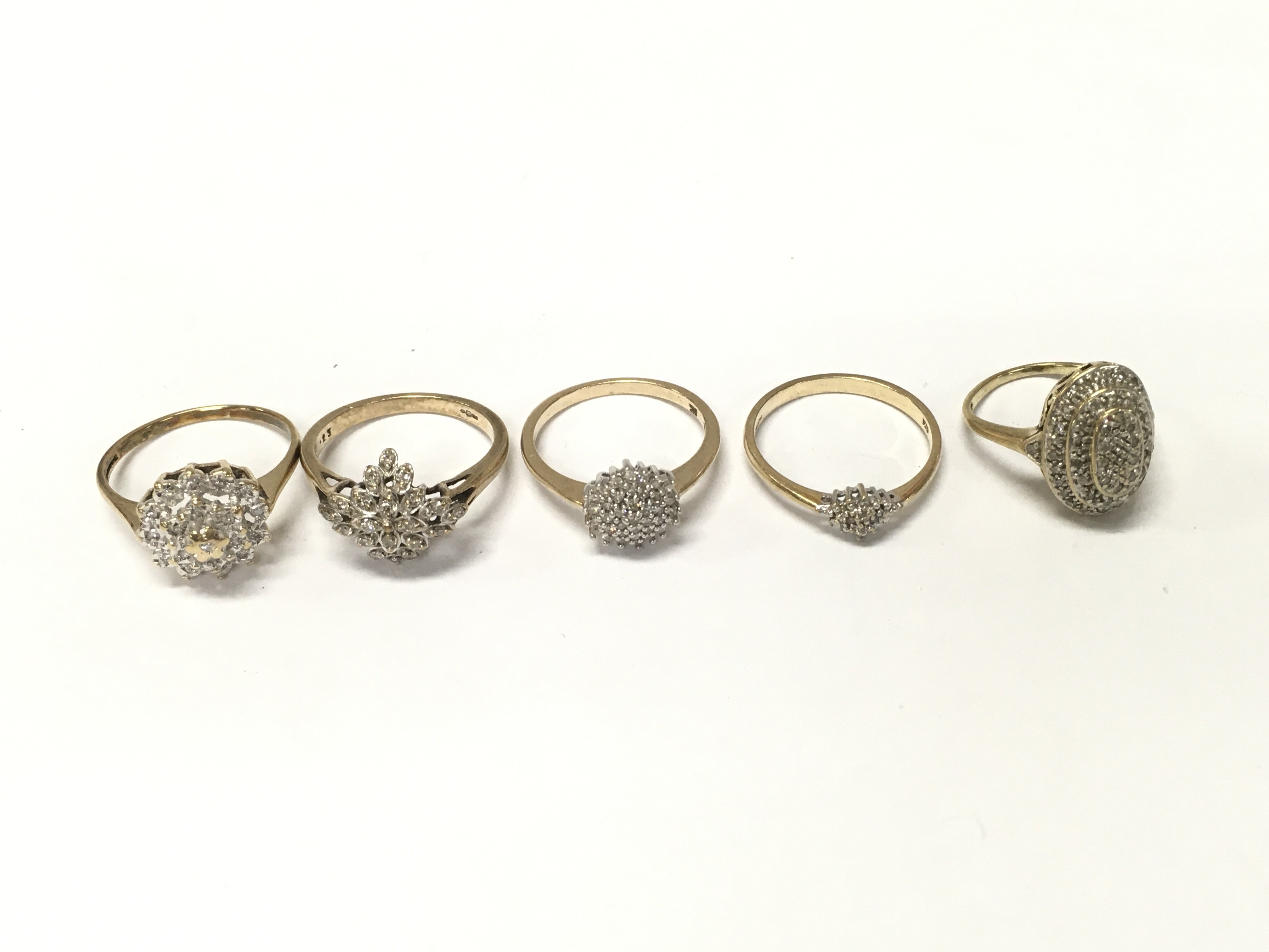 Five 9ct gold diamond cluster rings. Sizes I N N1/2 O and approximately 12.2g Postage A
