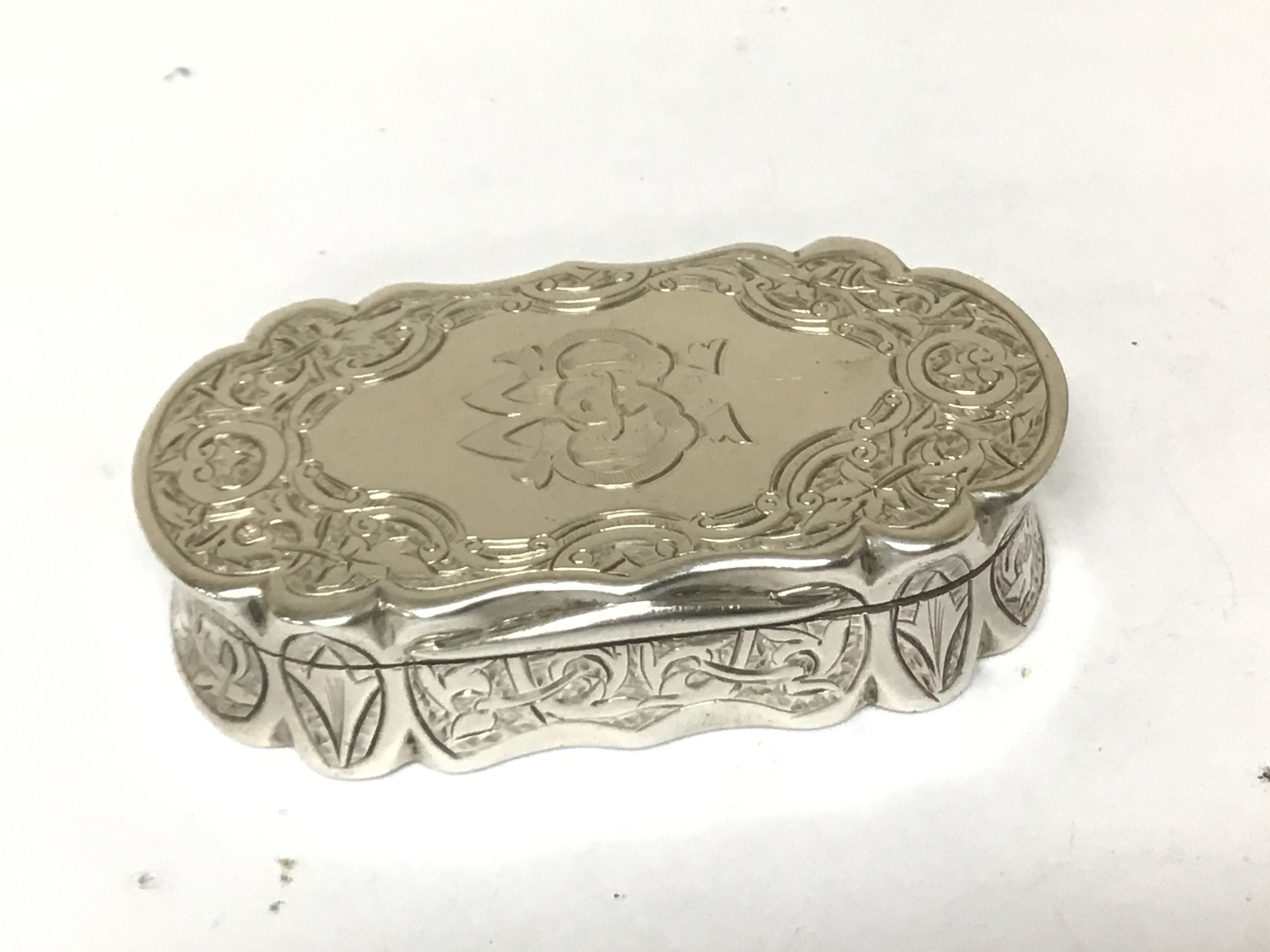 A Victorian silver Snuff box with Bright cut decoration Birmingham hallmarks.