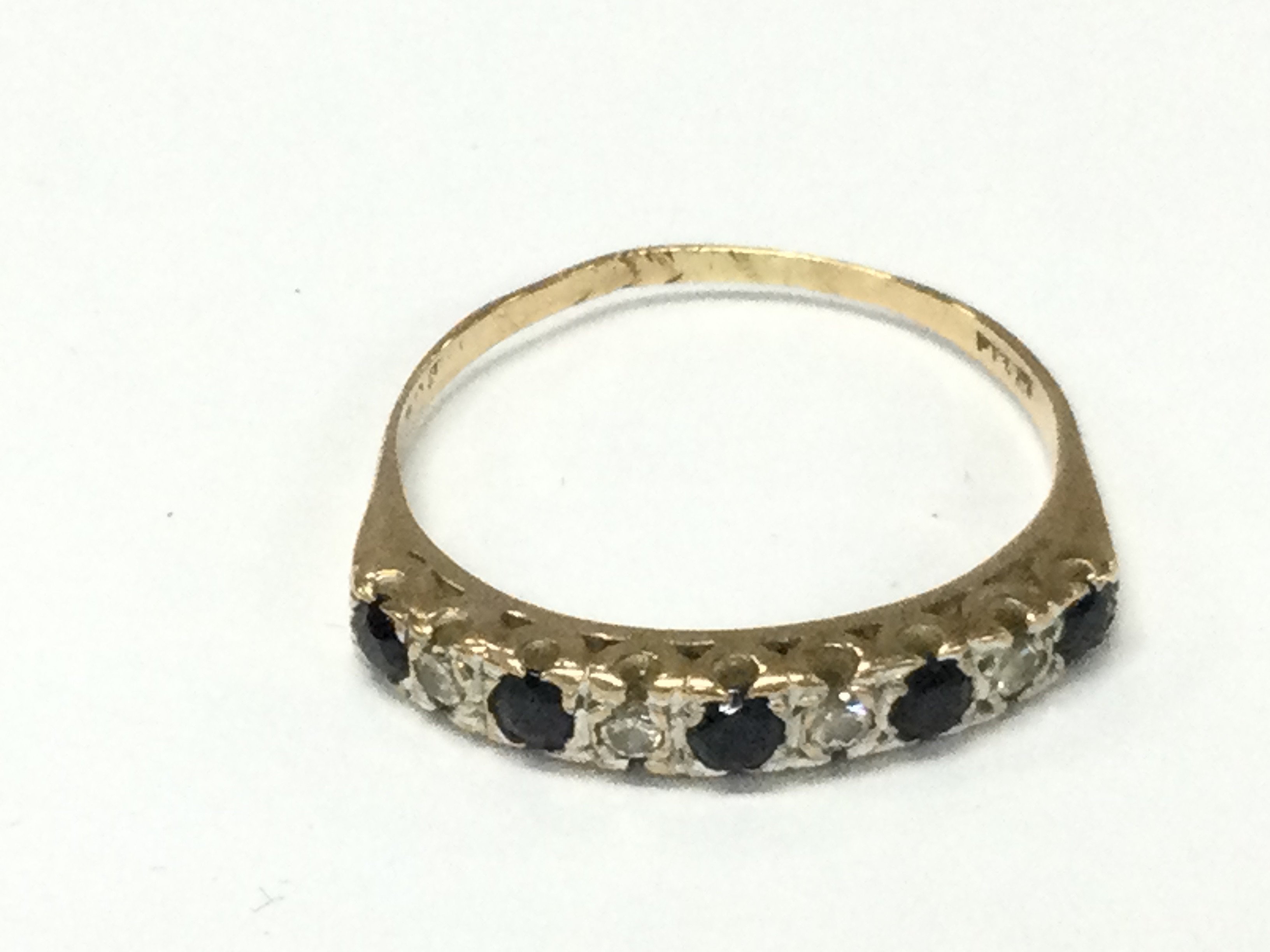 A 9ct gold diamond and sapphire set ring. V 1/2 and 2.67g