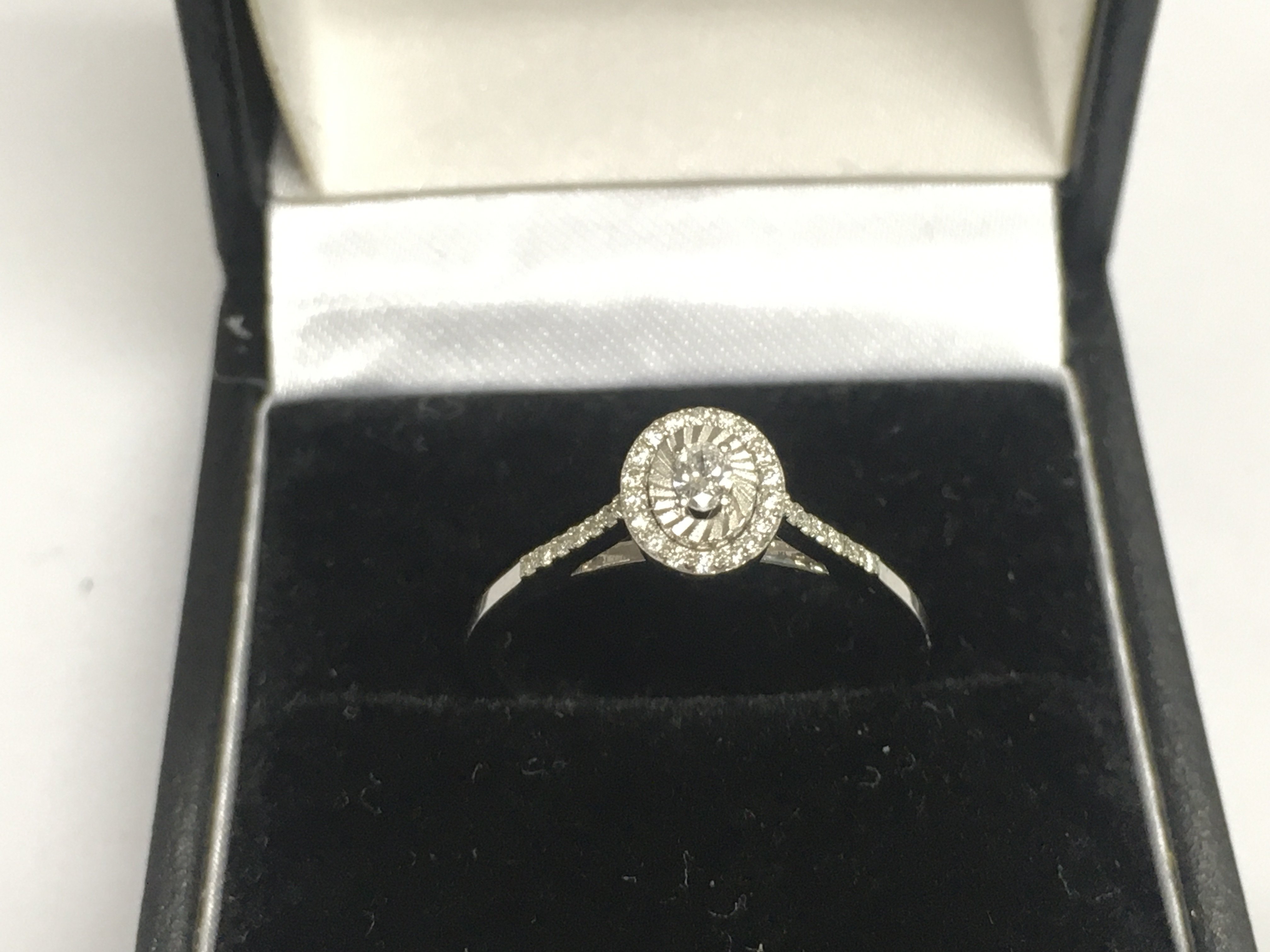 A 14ct white gold diamond cluster ring, approx 1.8g and approx size M-N. Shipping category A.