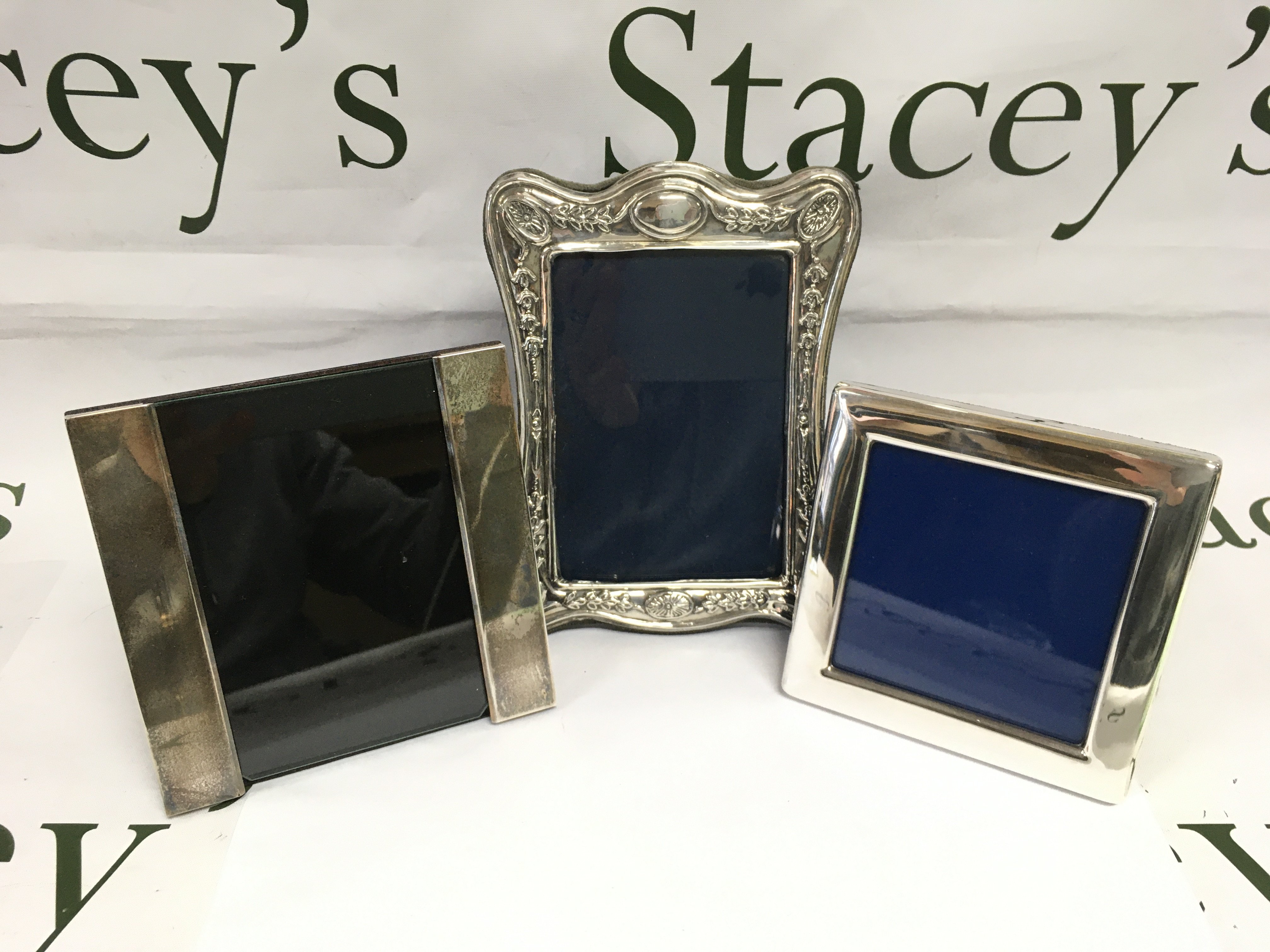 Three silver photo frames, largest approx 18cm in height. Shipping category B.