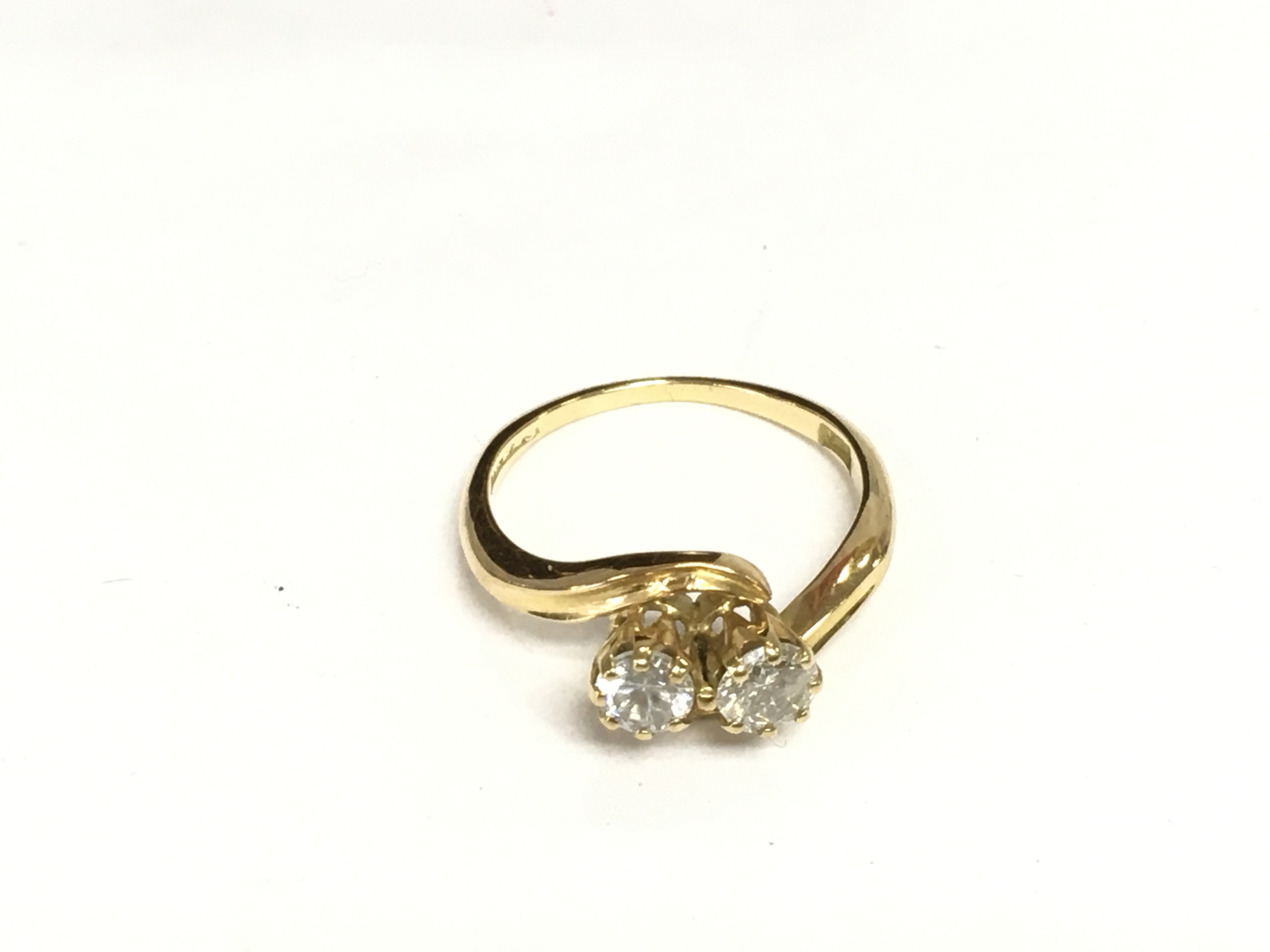 An 18ct gold two stone diamond twist ring, approx 3g and approx size K. Shipping category A.