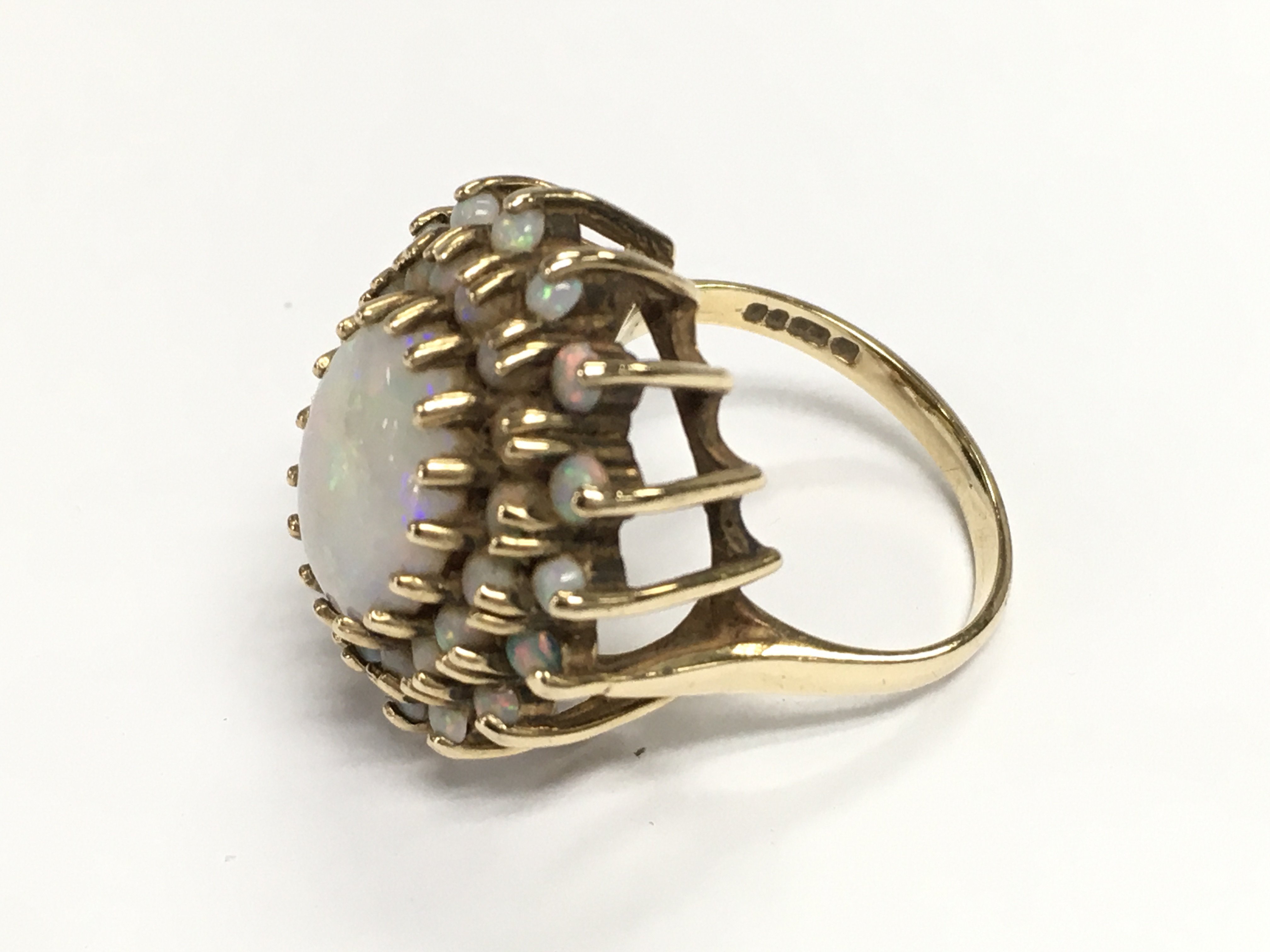 A 9ct gold Opal cluster ring. 6.45g and size M