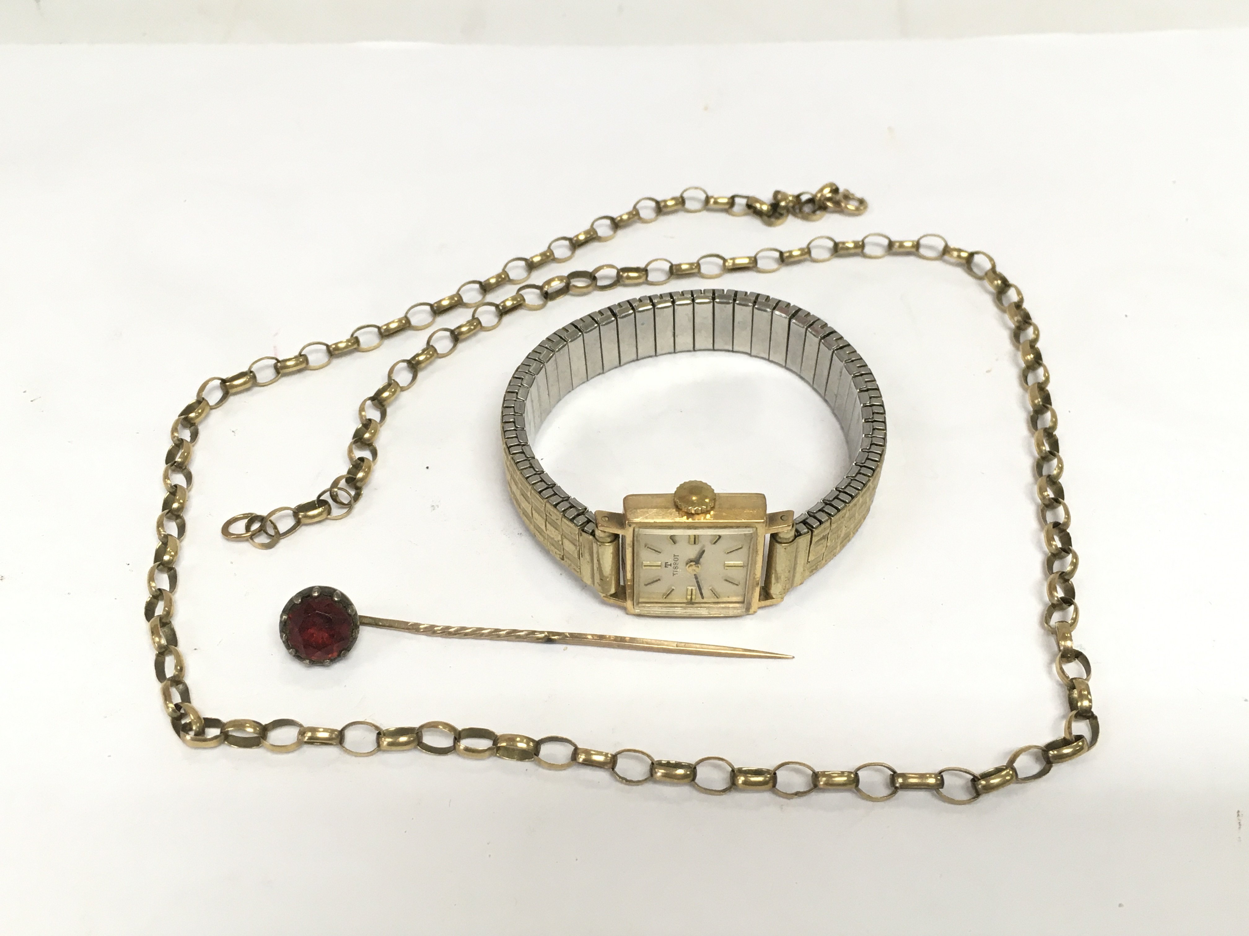 A ladies Tissot watch, gold belcher link chain and stick pin. Shipping category A.
