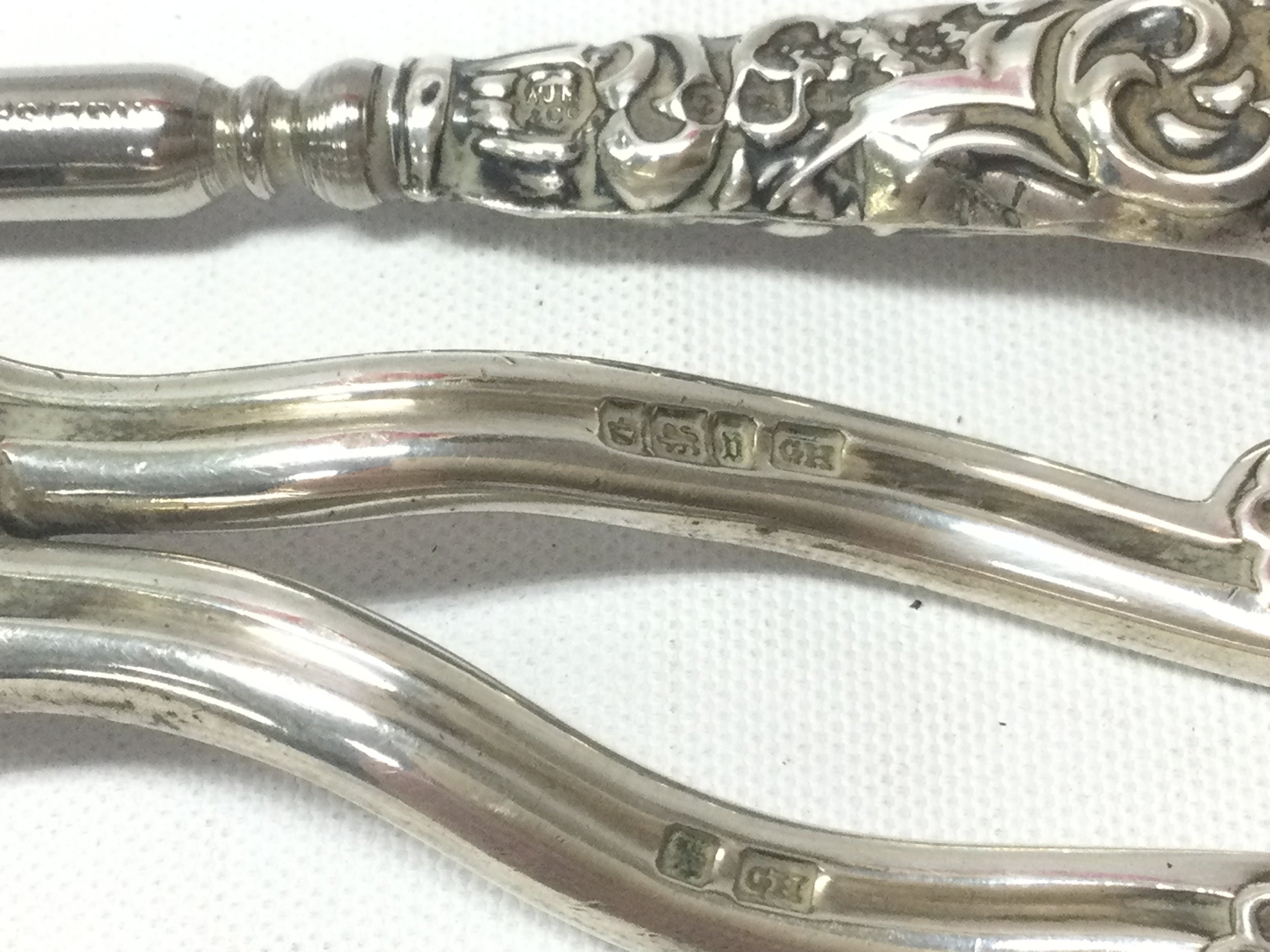 A pair of silver Asprey London grape scissors, silver handled button hook . Postage category B