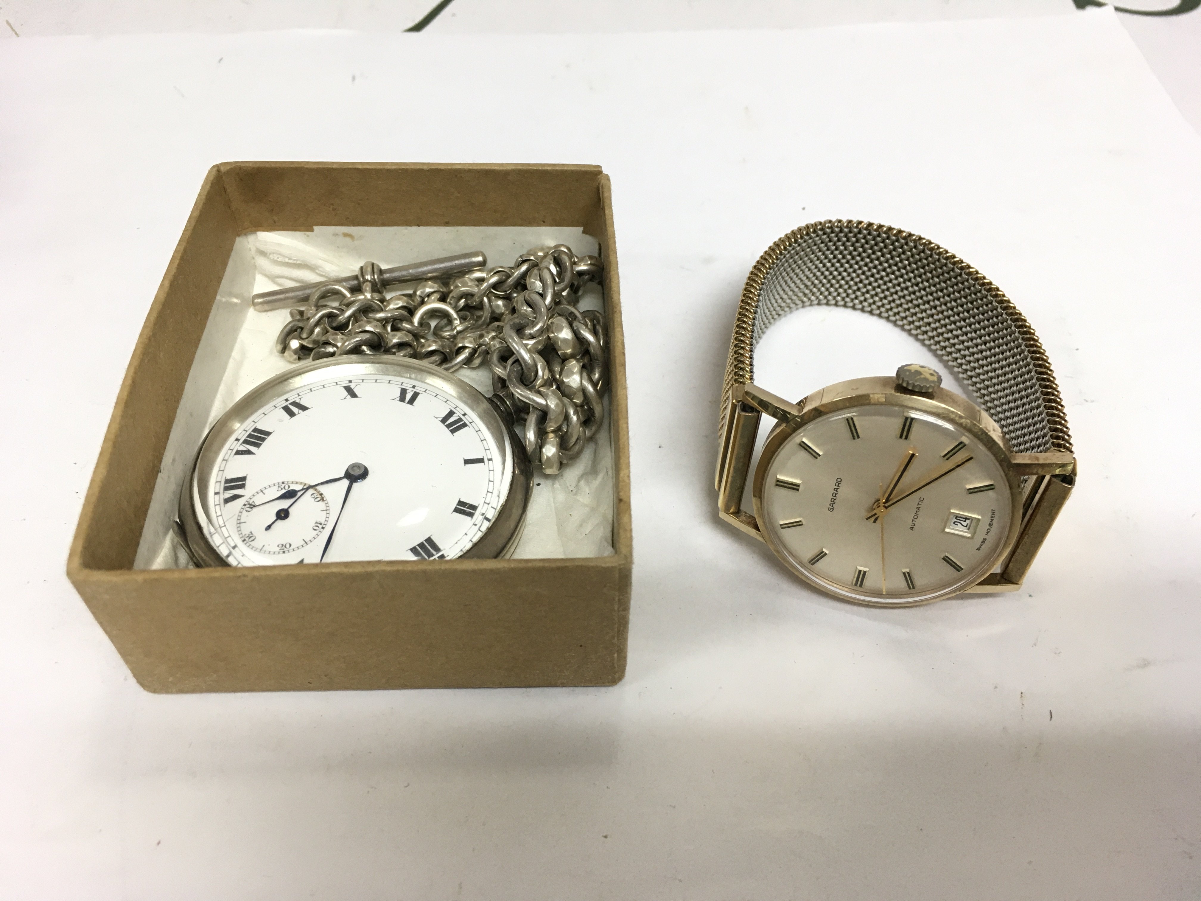 A gents Garrard watch and a silver cased pocket watch and chain (2). Shipping category A.
