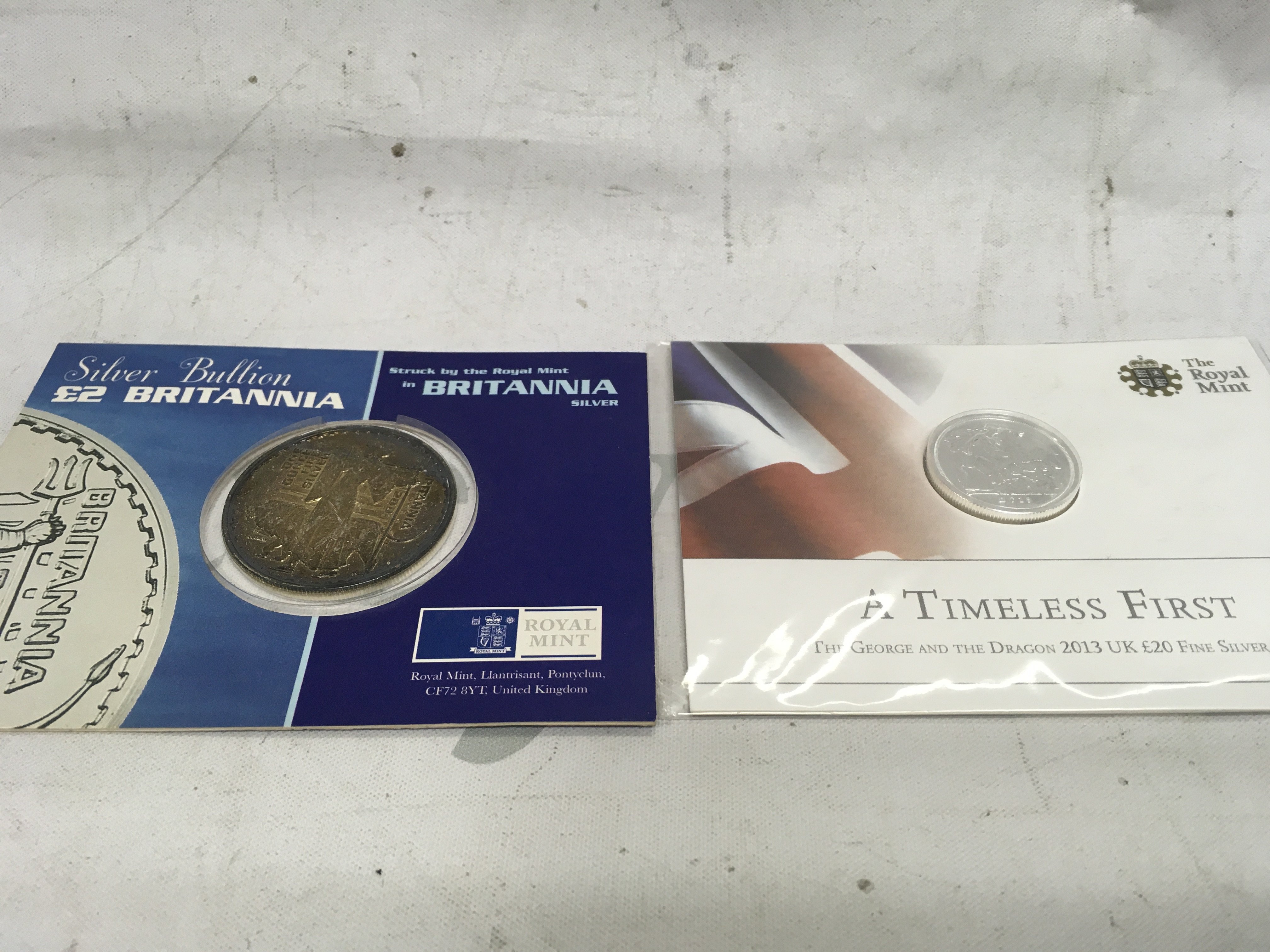 A silver 2001 Britannia and a 2013 fine silver &#201326627520 coin.
