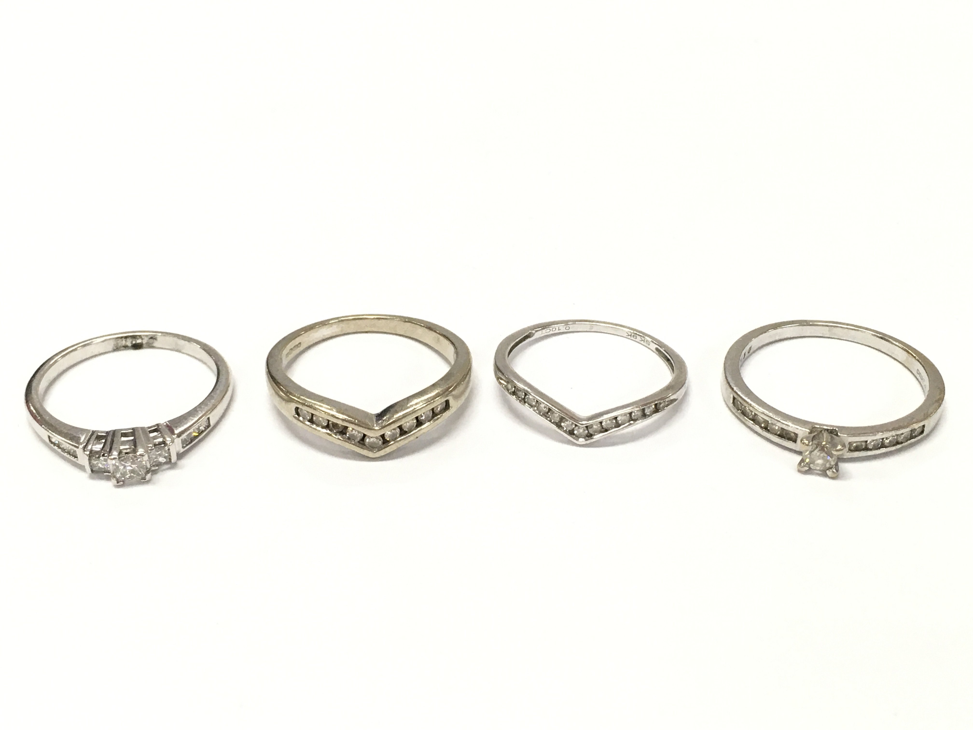 A Collection of 9ct white gold white stone set rings ,7.8g total weight . Sizes L and O. Postage category A