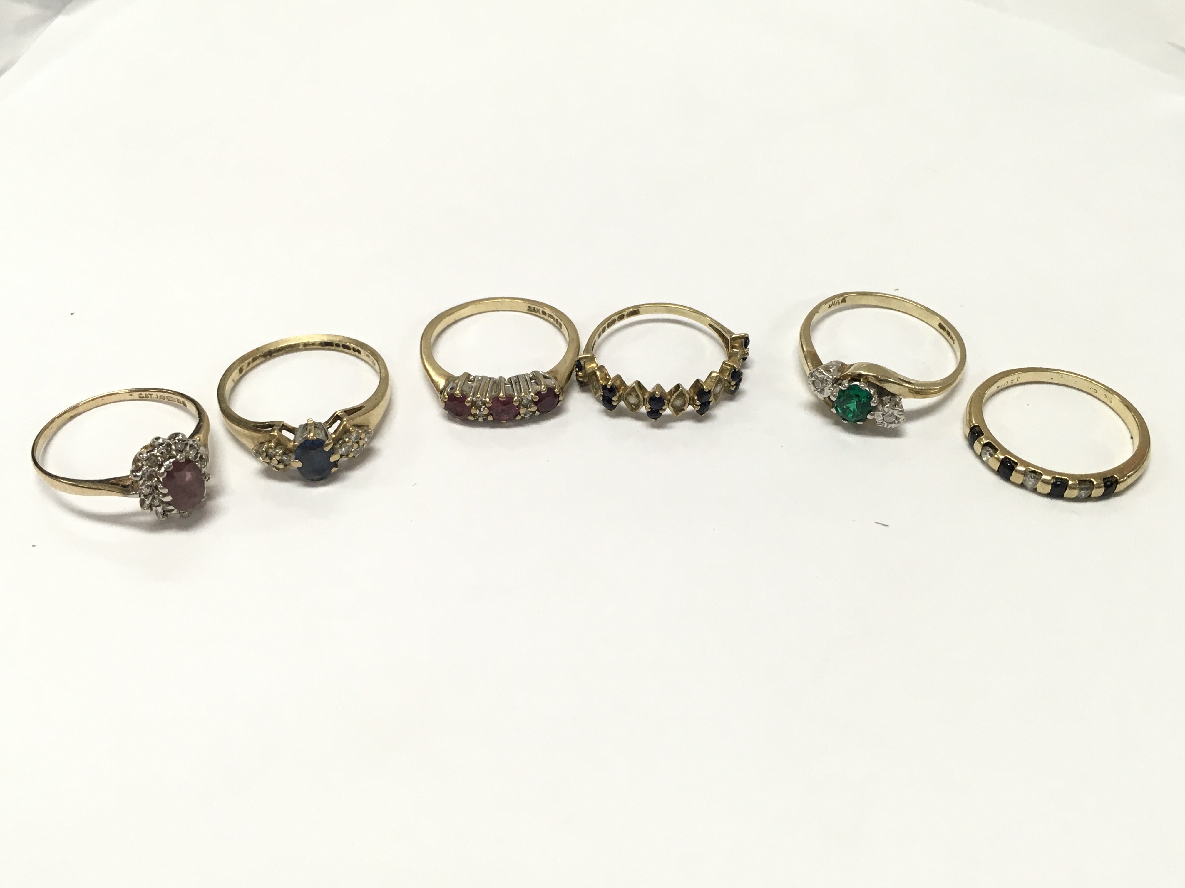 Six 9 carat gold rings set with various gemstones , 11g total weight, various sizes J to O. postage category A
