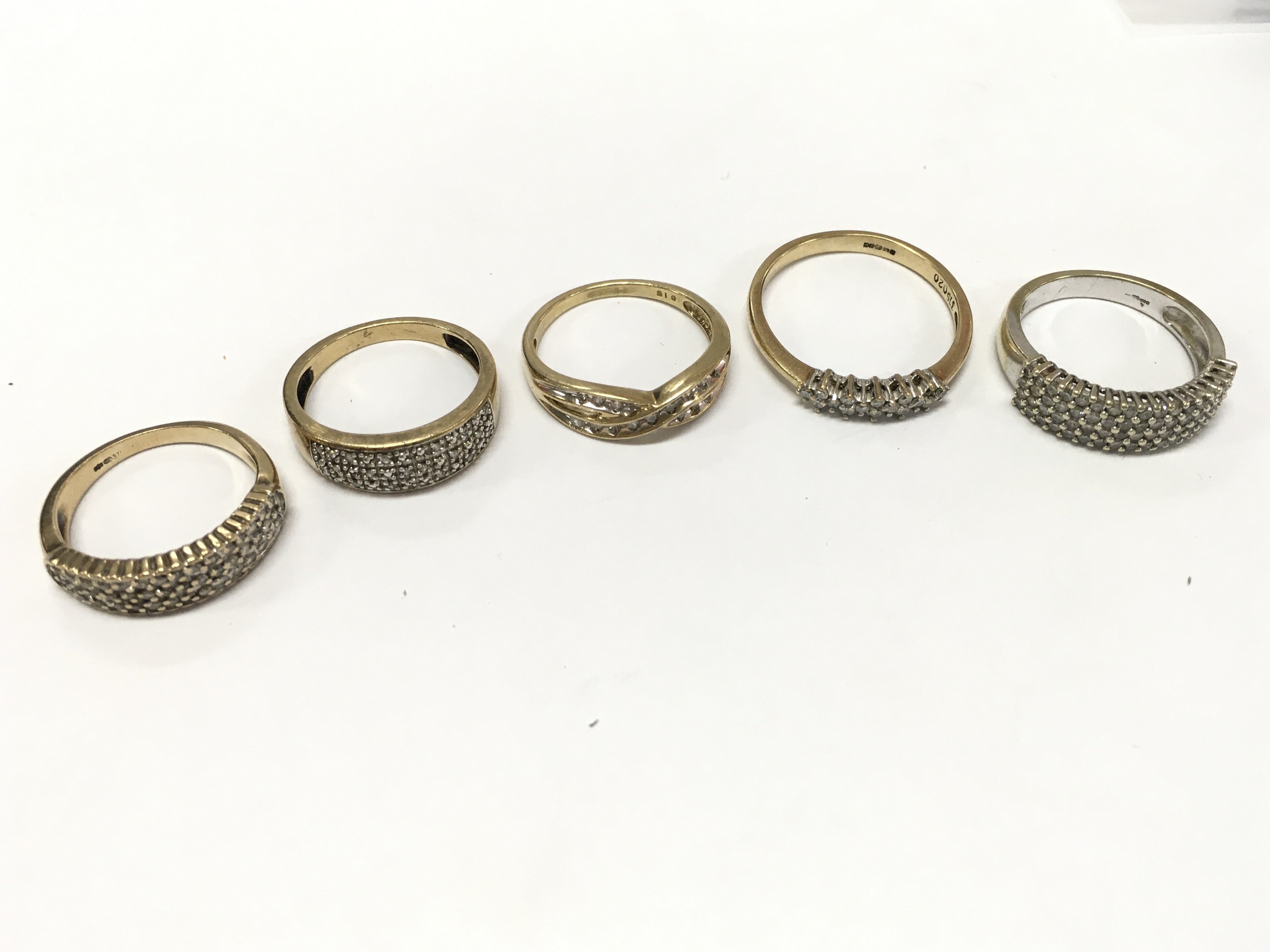 9ct gold rings diamond and Moissanite set . Some unmarked. 13g total weight. Sizes N , O etc.Postage cat a