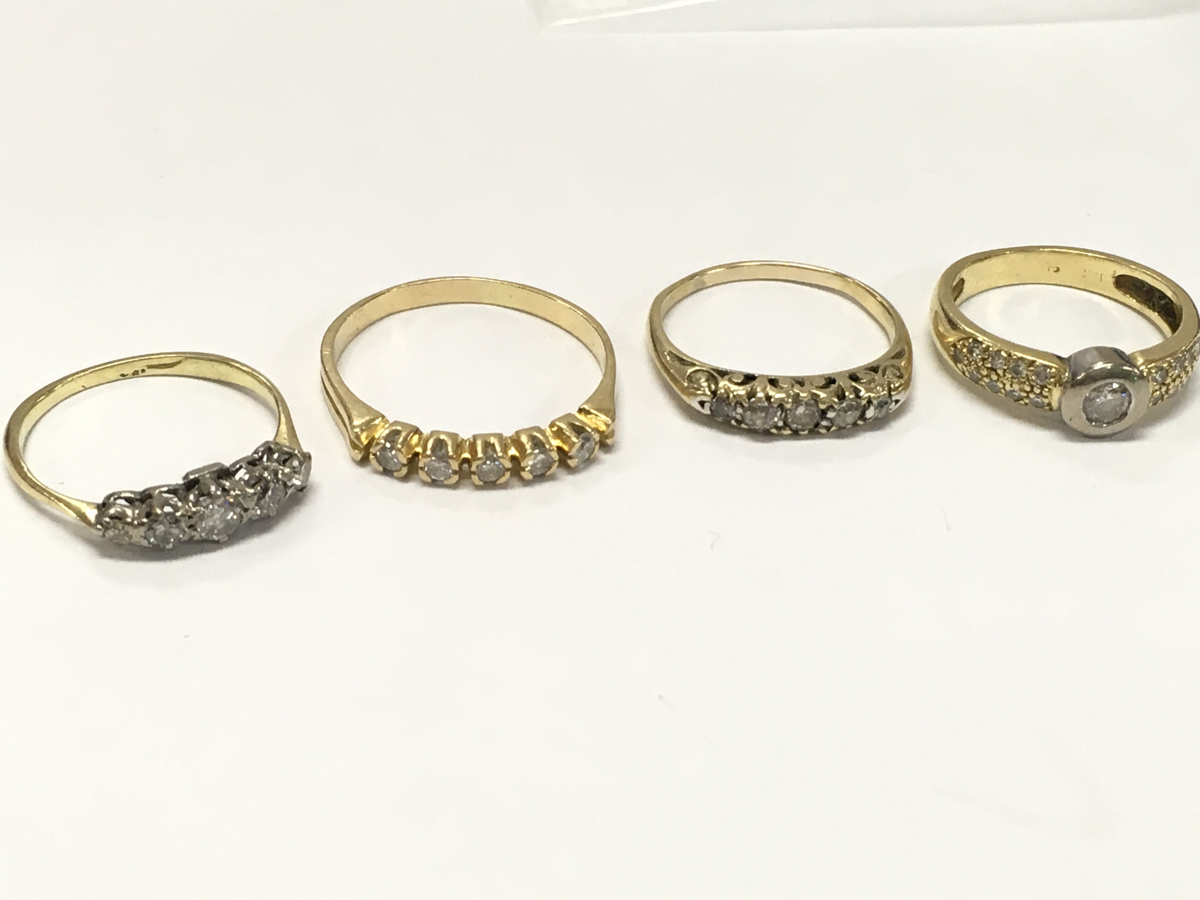 Four High carat gold Moissanite set rings. Sizes K, Q etc . 10g total weight. Postage category A