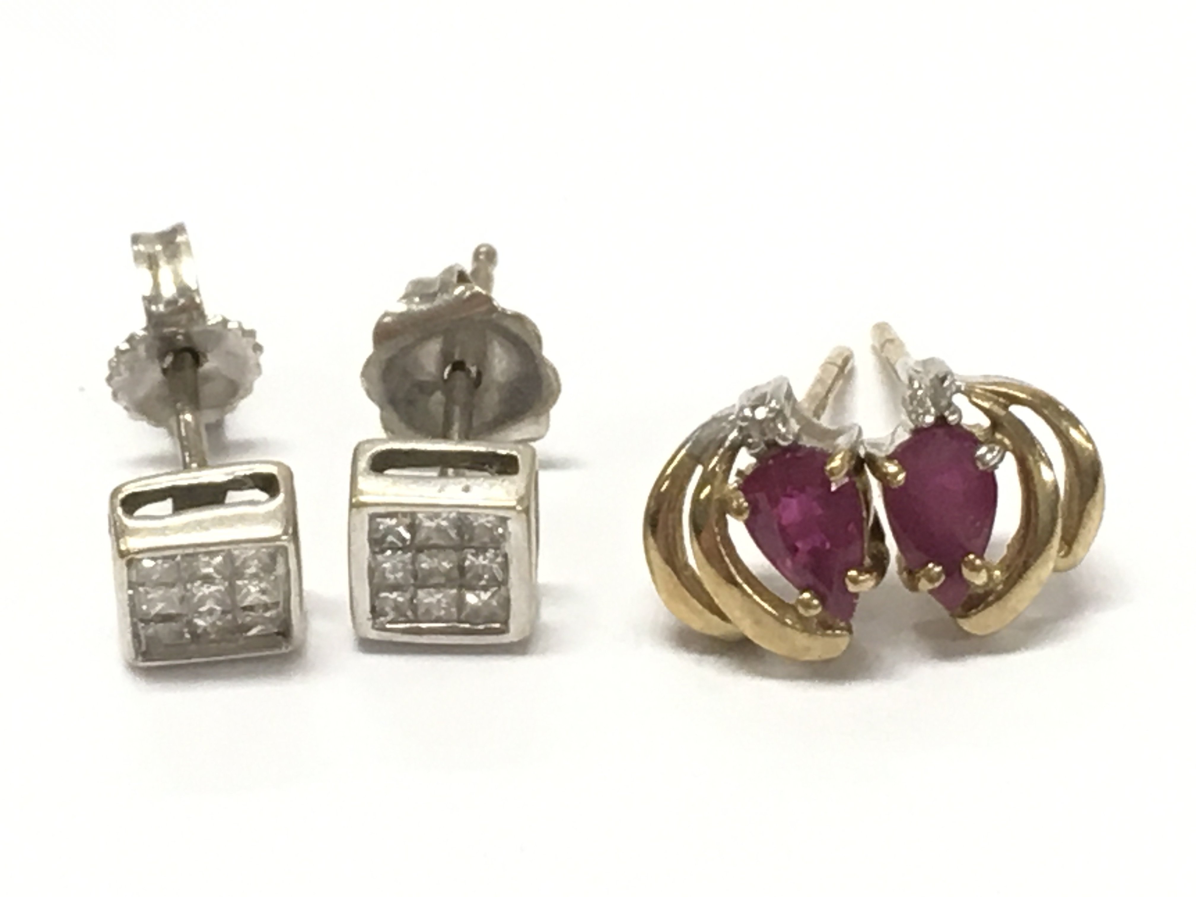 9 carat gold Earrings diamond set and ruby set . 2g total weight .postage category A