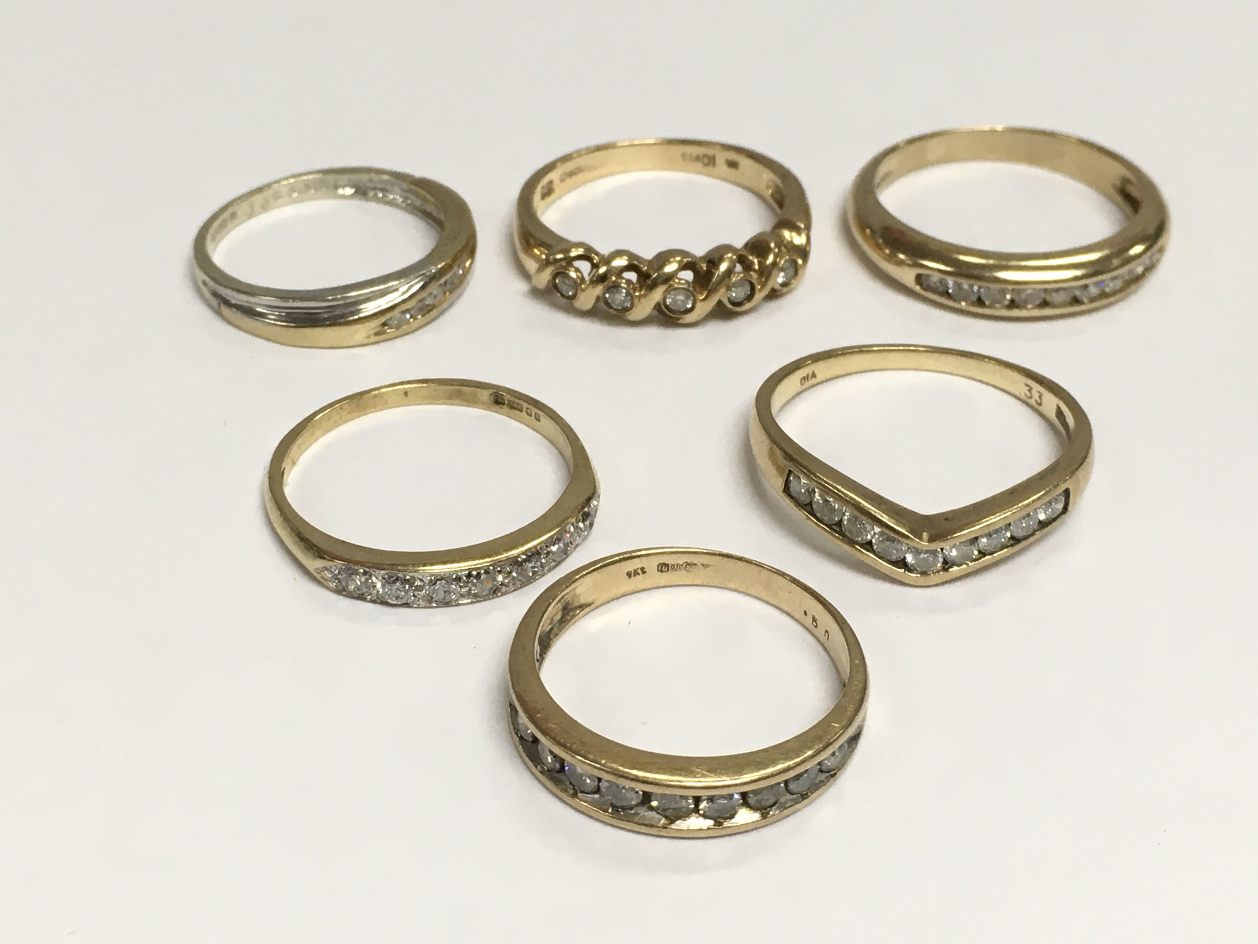 Six 9ct gold, diamond and moissanite half hoop rings, total approx weight 13.7g. Shipping category A.