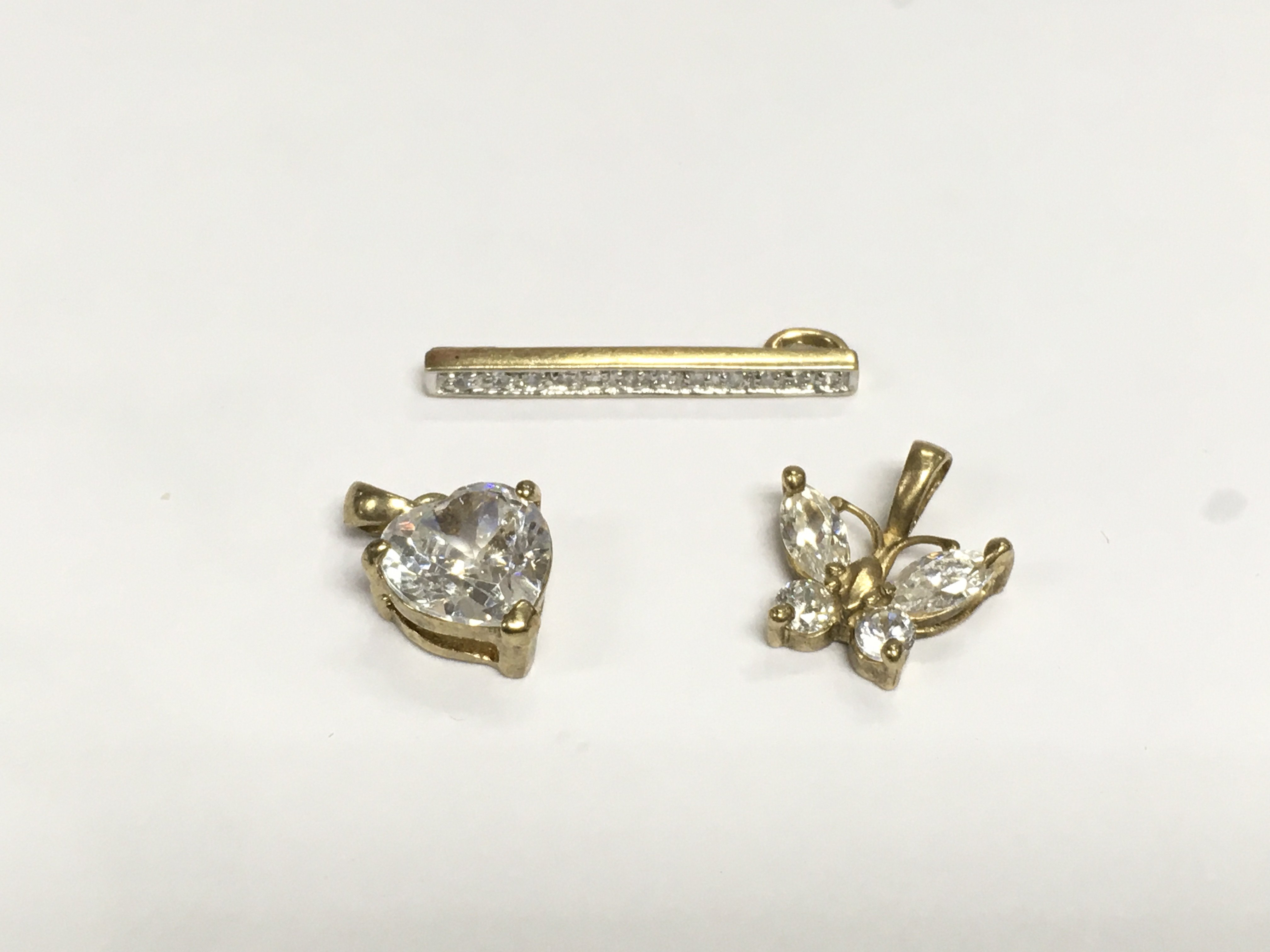 Three 9ct gold pendants set with stones, approx total weight 2.9g. Shipping category A.