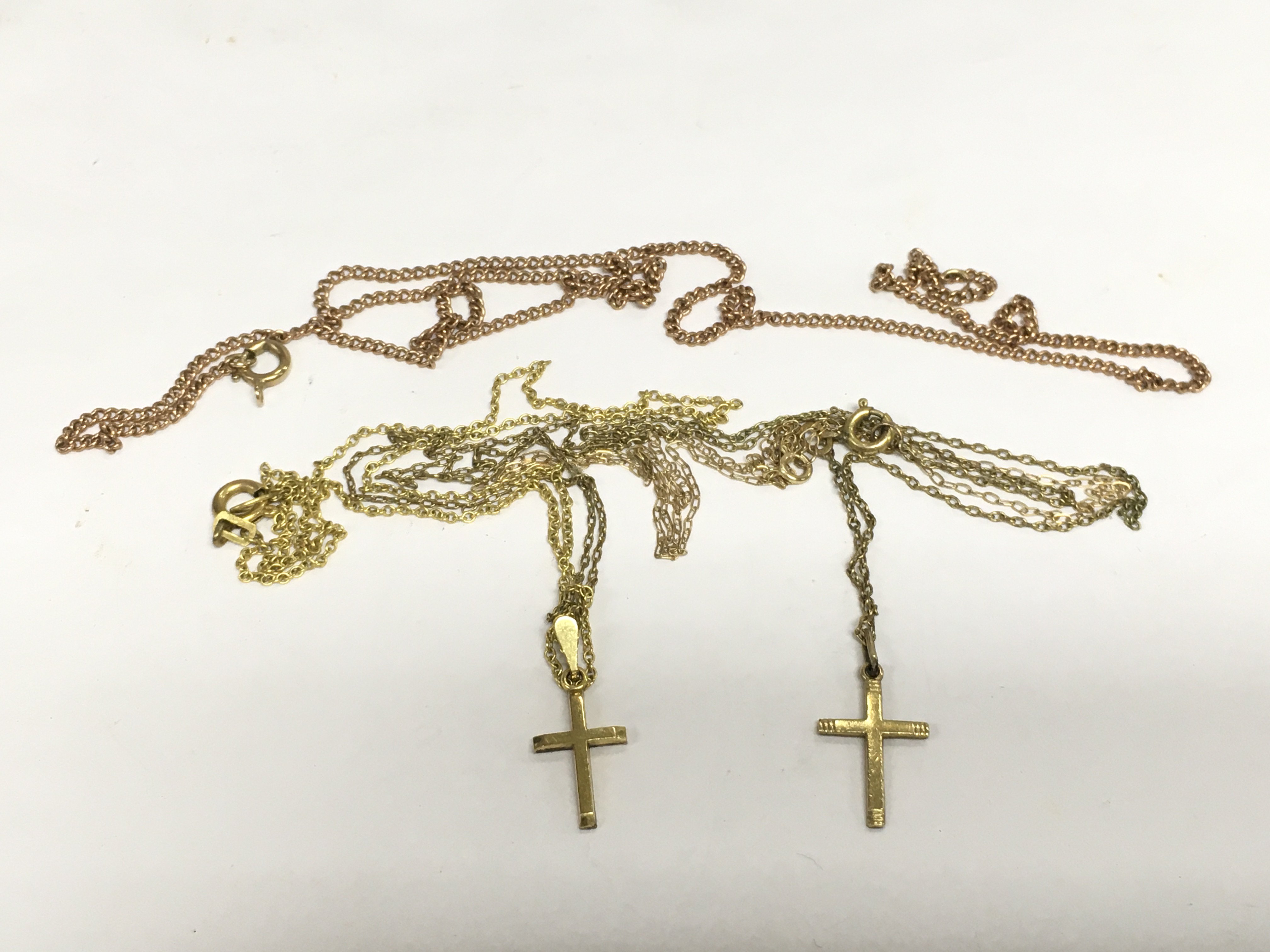 Three gold chains and two cross pendants, approx total weight 7g. Shipping category A.