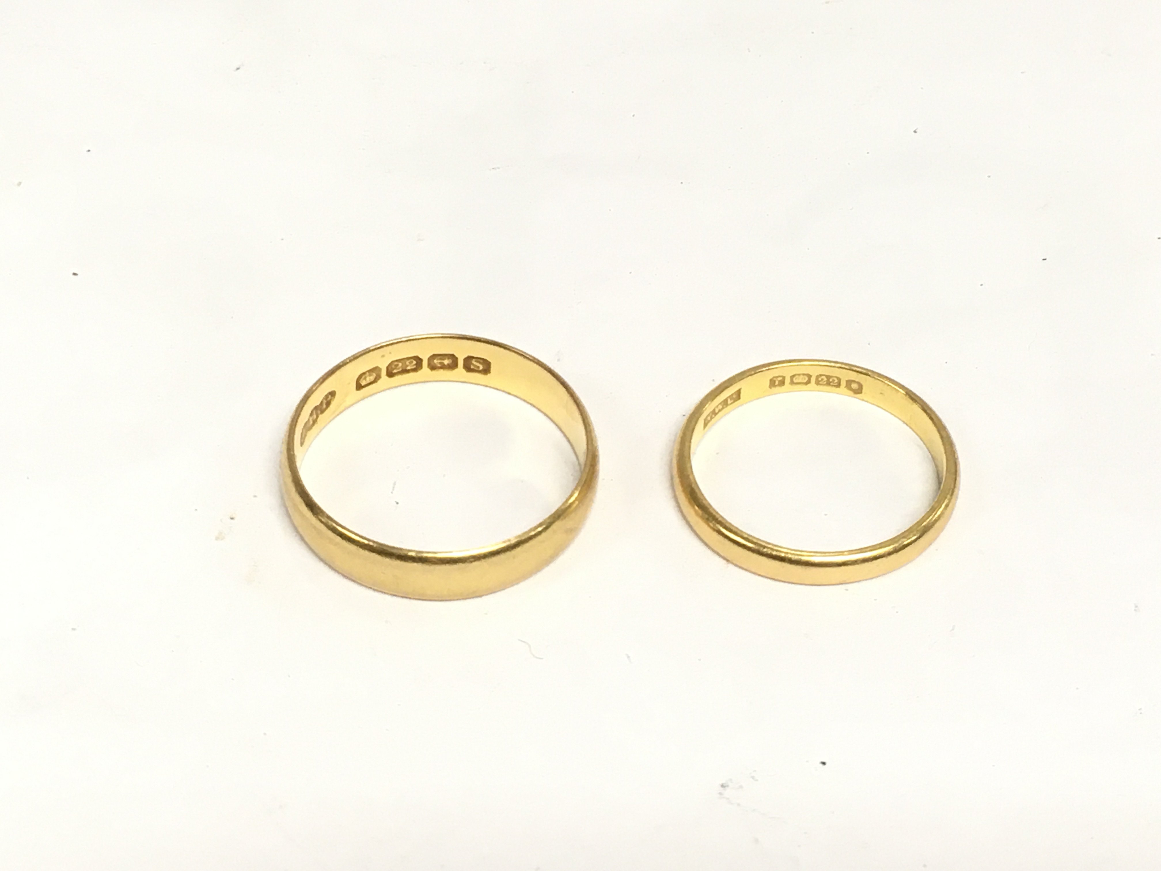 Withdrawn -Two 22ct gold wedding bands, approx total weight 8.4g and approx sizes O and U. Shipping category A.