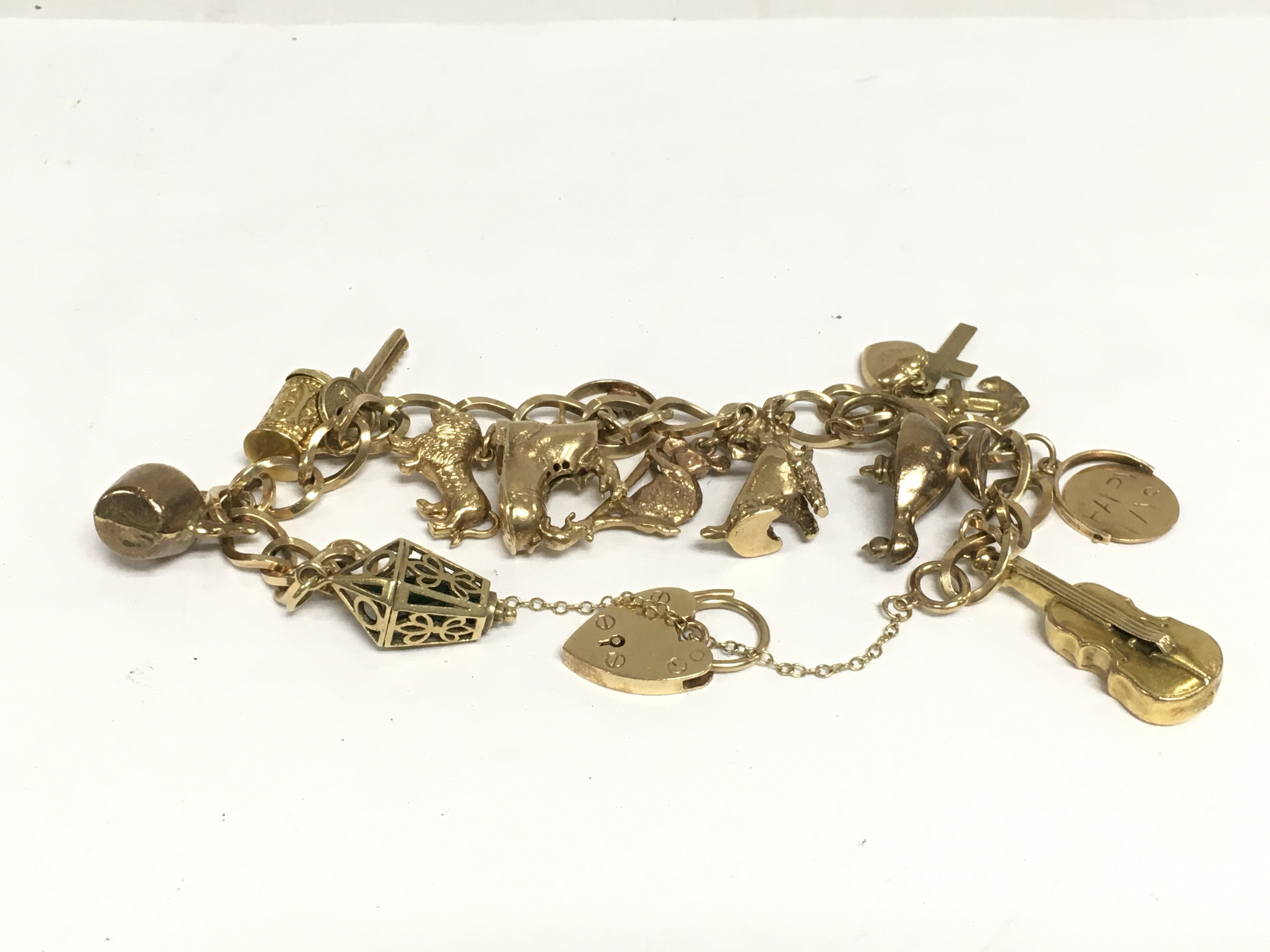 A 9ct gold charm bracelet, approx 37g. Shipping category A.