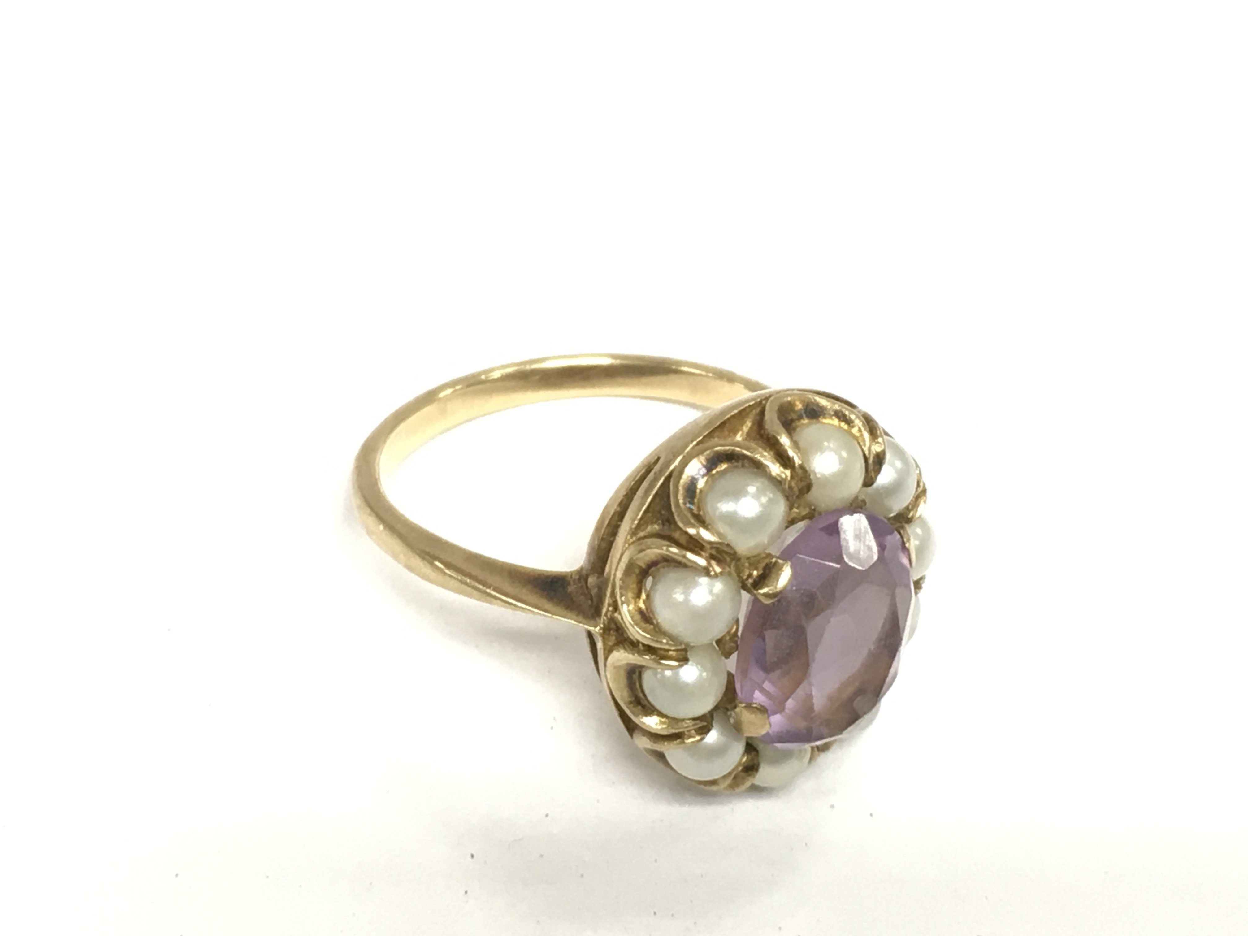 A 9ct gold, amethyst and pearl ring, approx 5g and approx size N. Shipping category A.