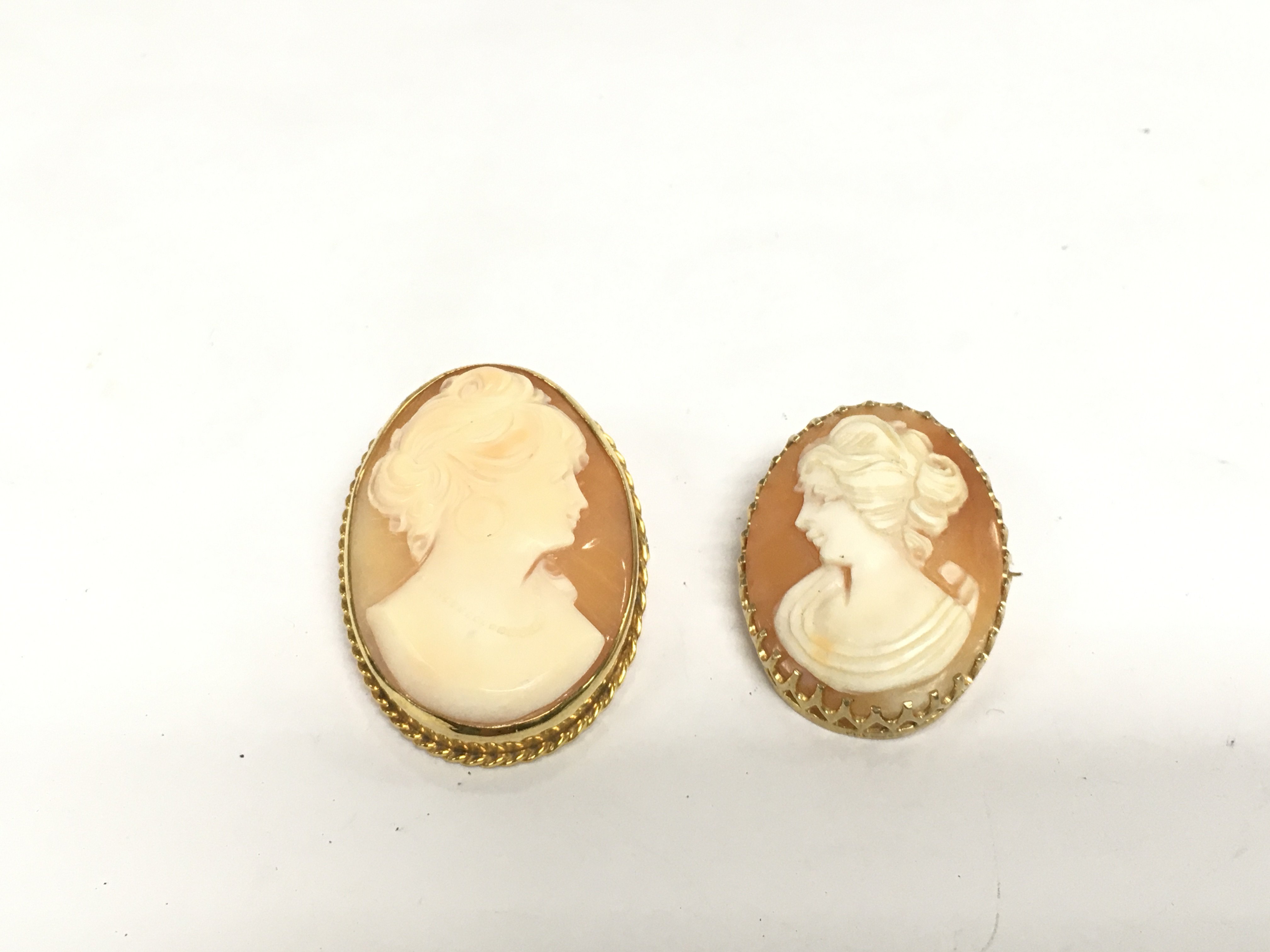 Two 9ct gold cameo brooches, total approx 14.8g. Shipping category A.