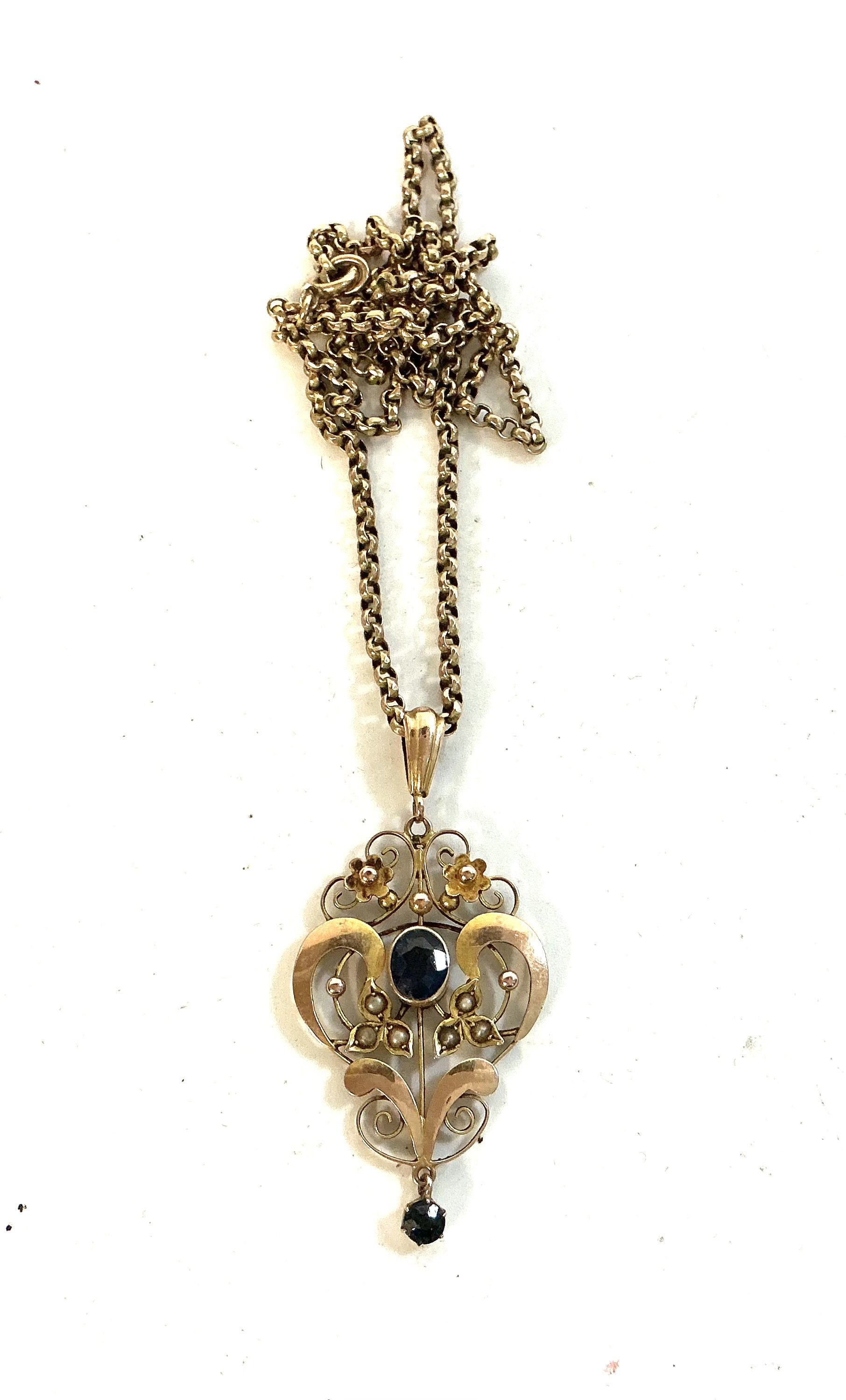 A good art nouveau 9ct gold pendant and chains together inset with sapphire and seed pearls.