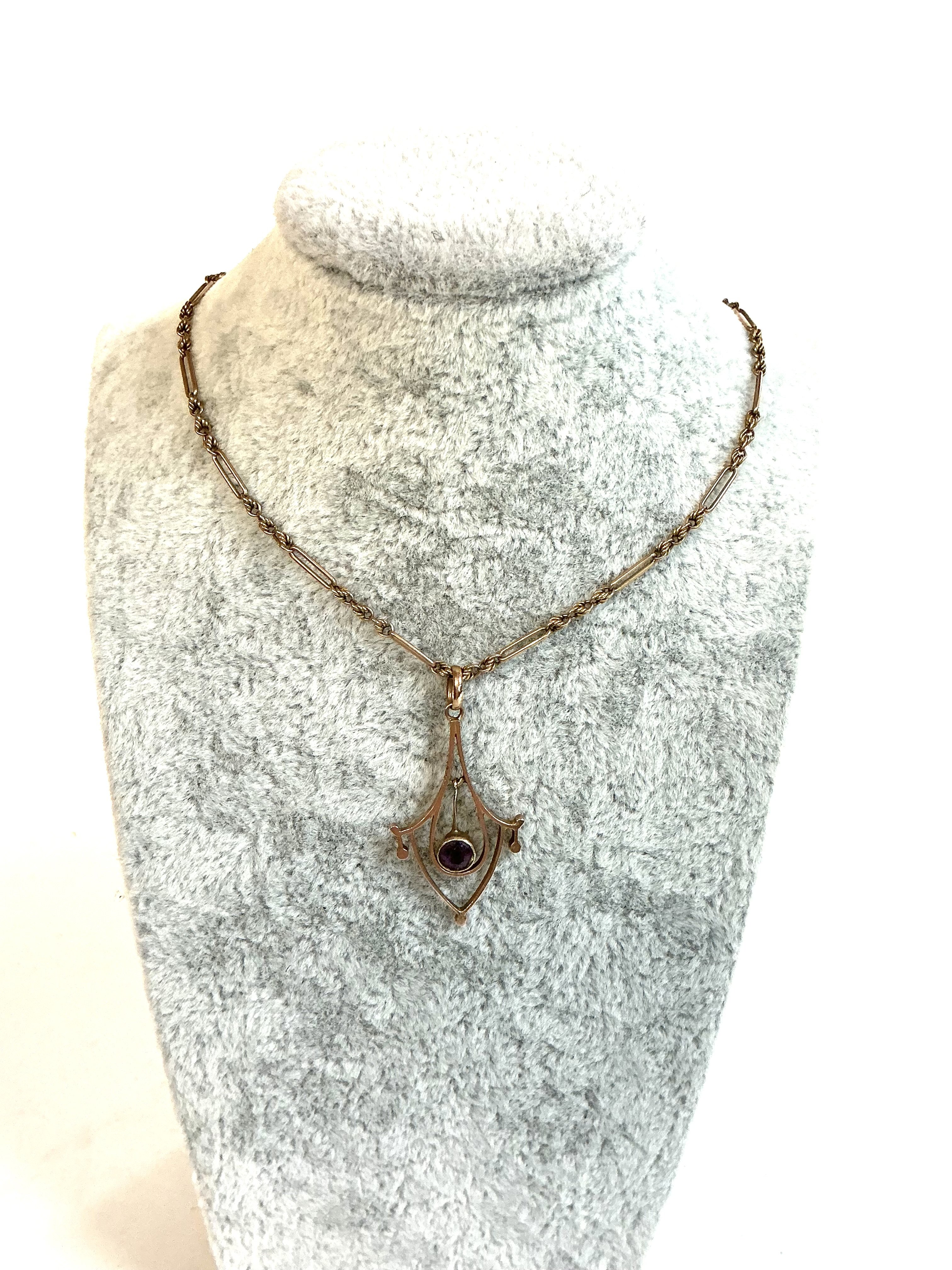 An Edwardian 9ct gold pendant and fancy link chain.
