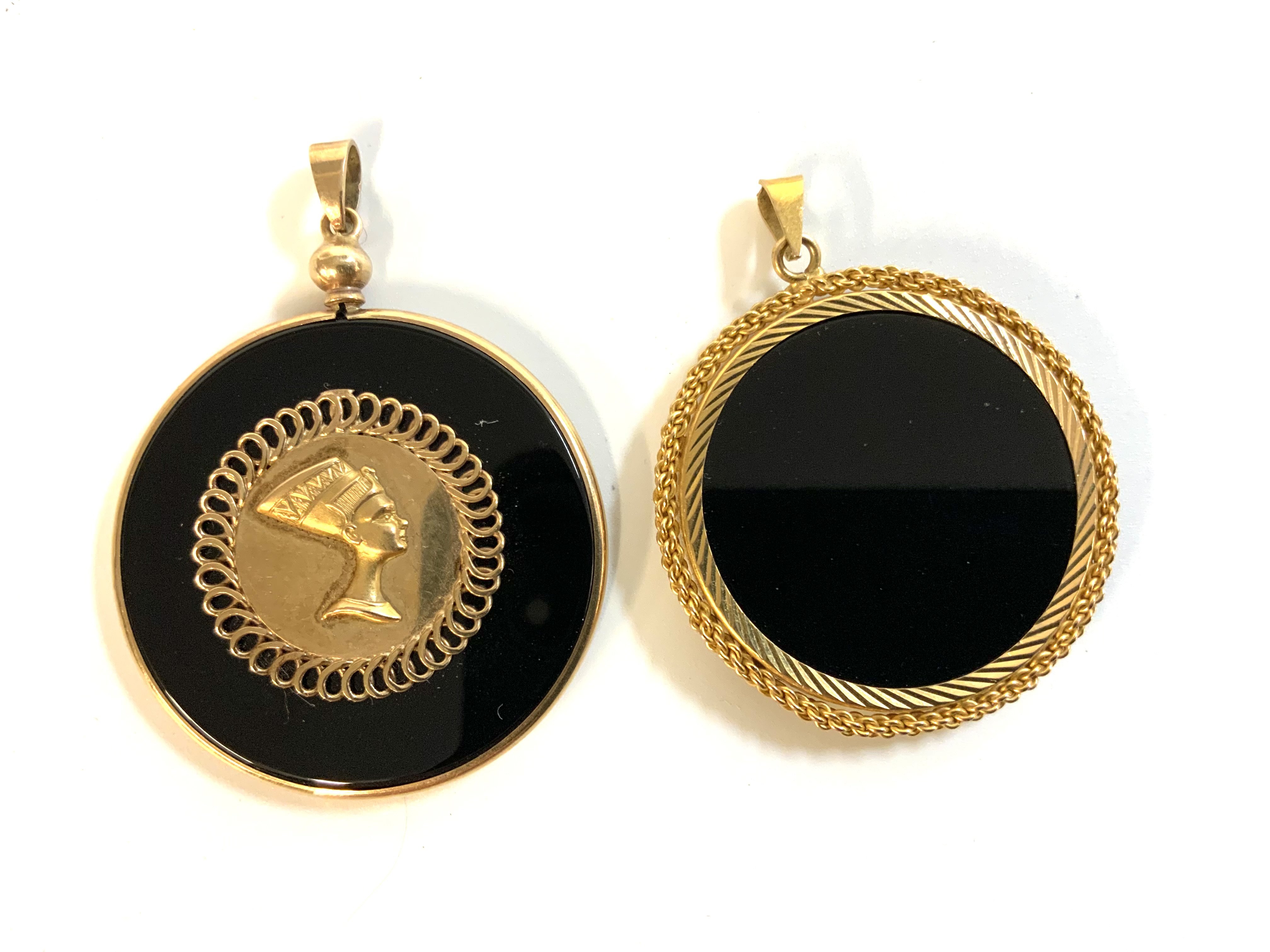 2 9ct gold mounted pendants, one with applied panel of Nefertitis head. (A)