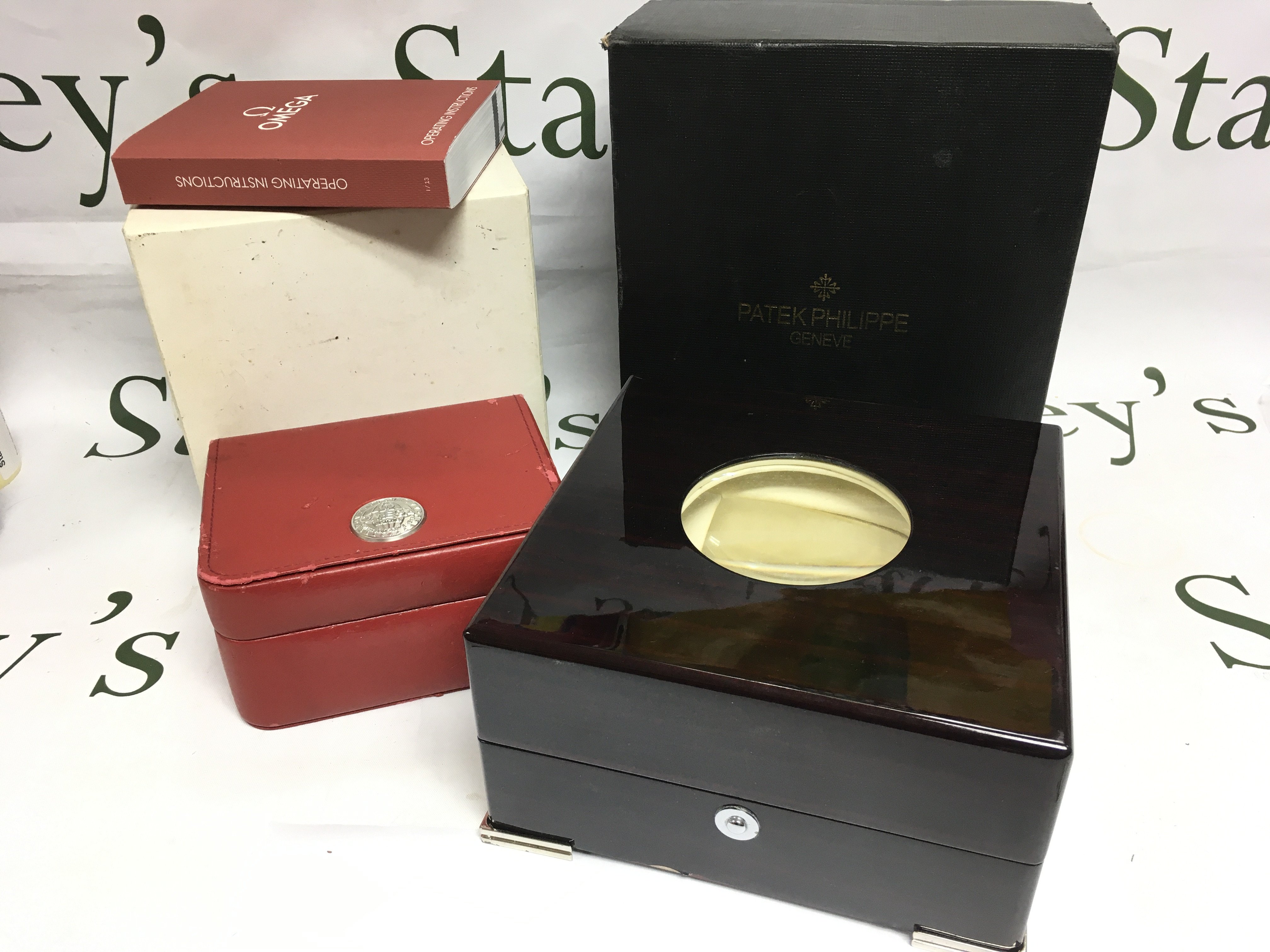 An Omega watch box and instruction booklet together with a Patek Philippe watch box (2). Shipping category B.