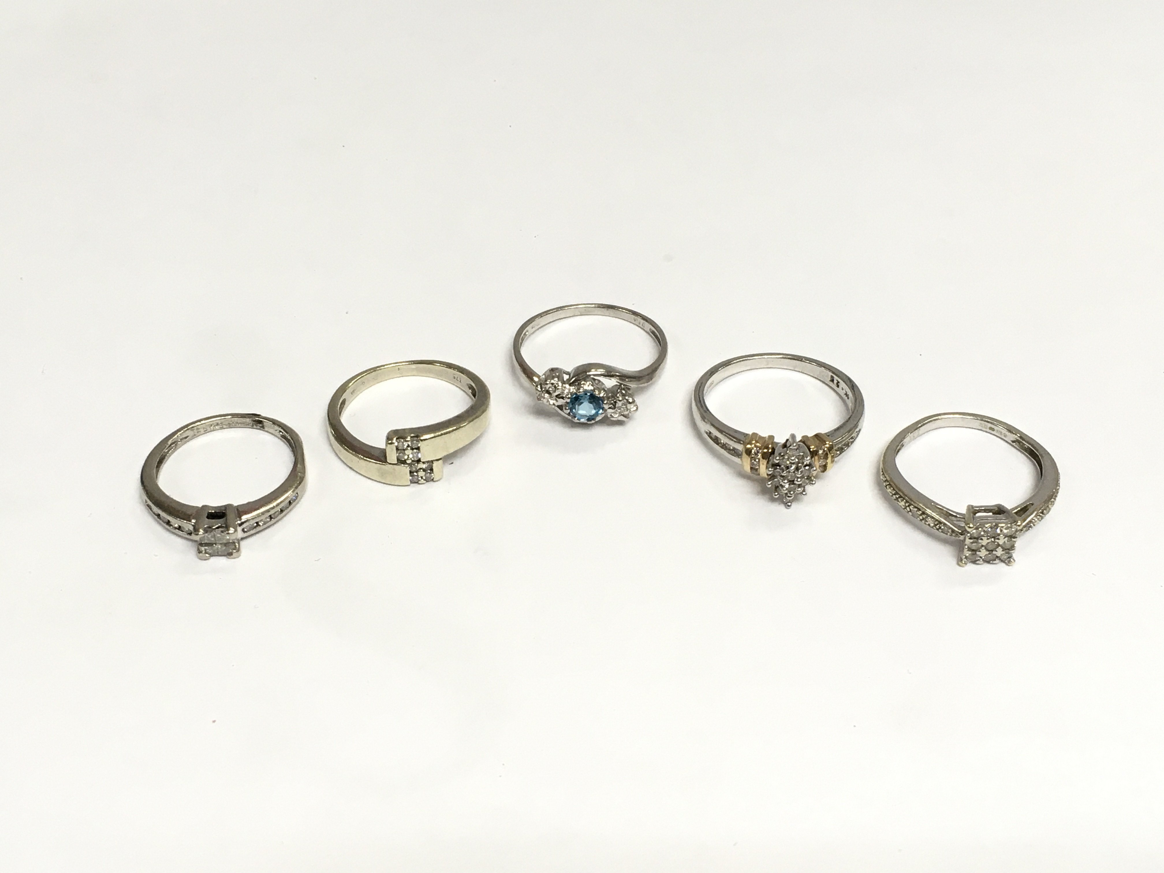 Five rings comprising white gold and platinum examples set with diamonds, total approx 12.5g. Shipping category A.