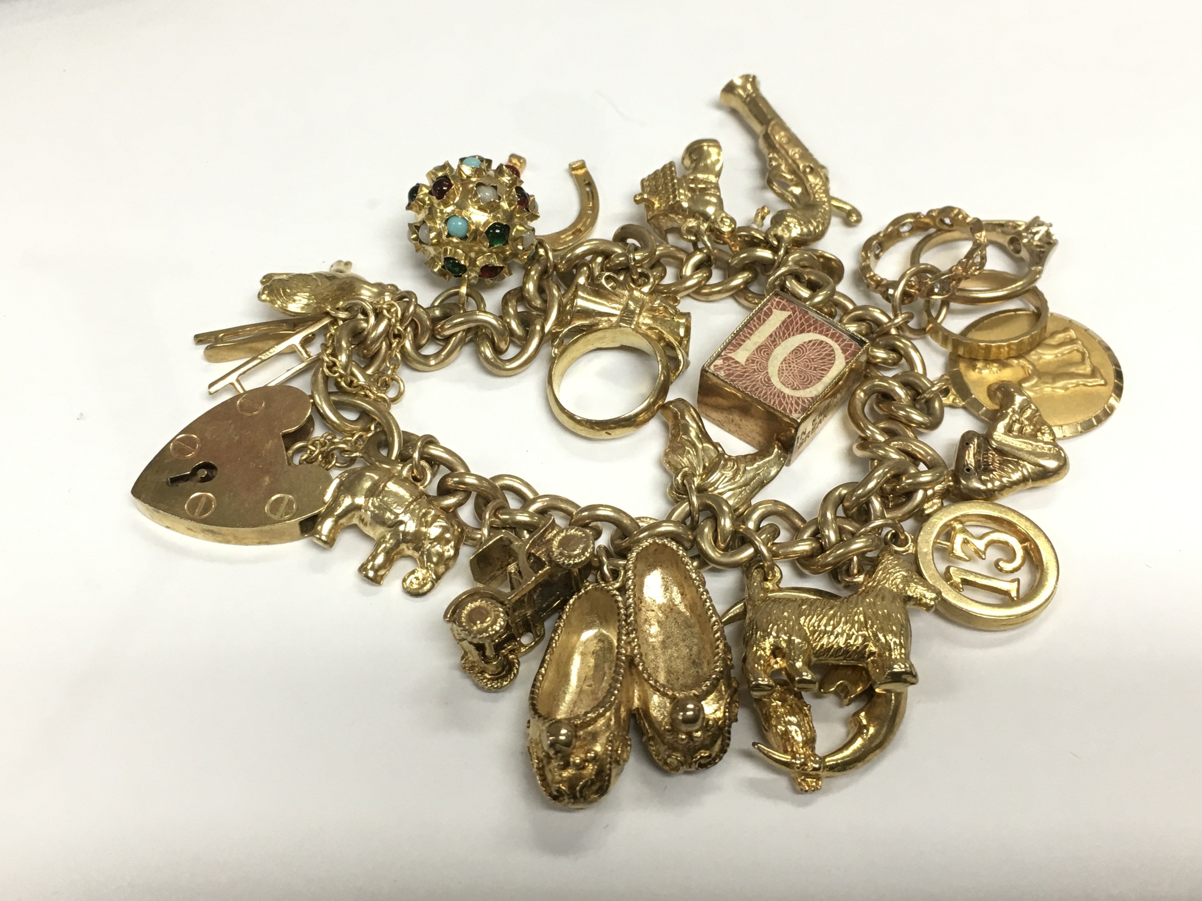 A 9ct gold charm bracelet, approx 58.4g. Shipping category A.