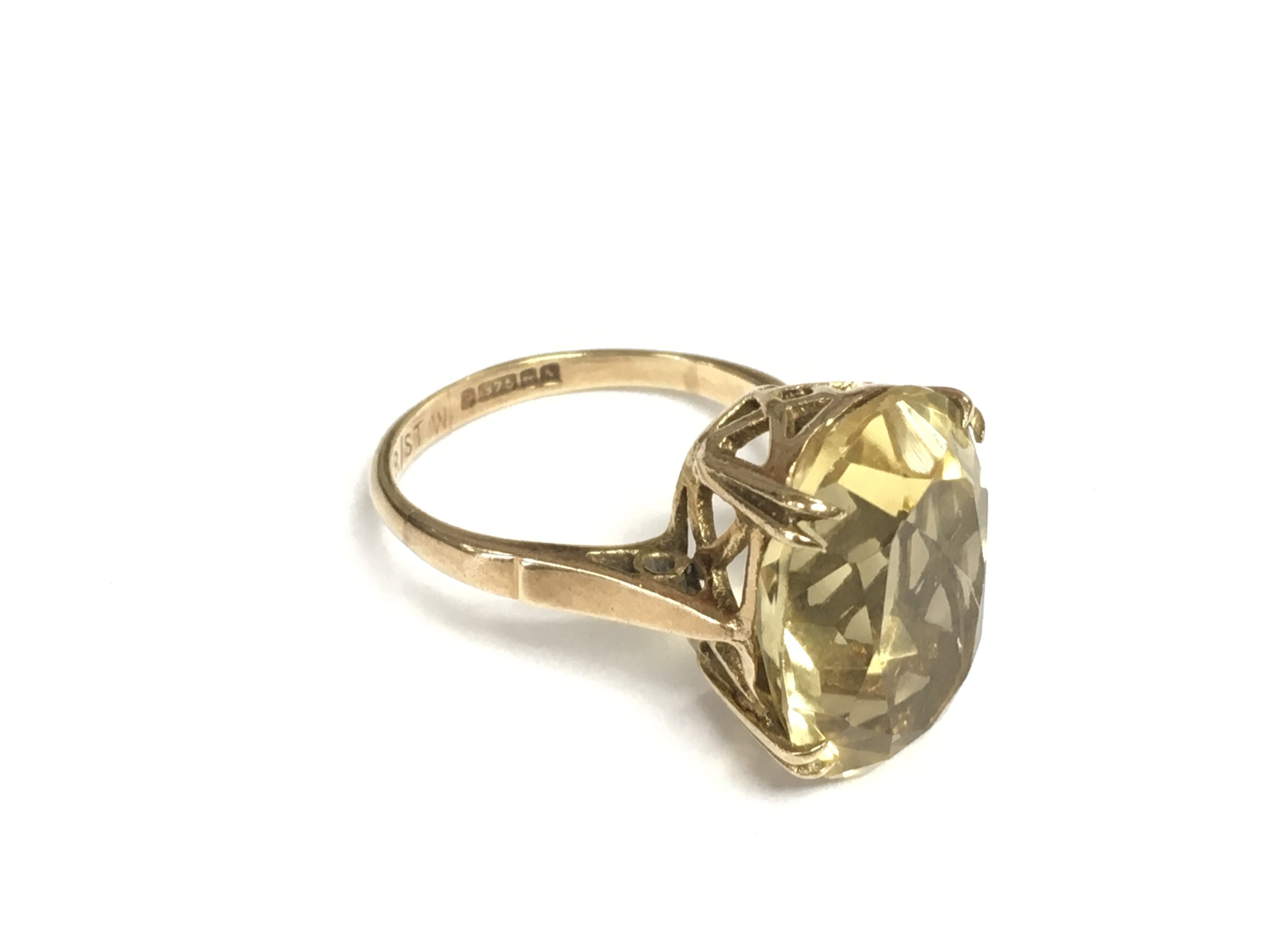 A 9ct gold ring set with a yellow quartz, approx 4.5g and approx size L. Shipping category A.