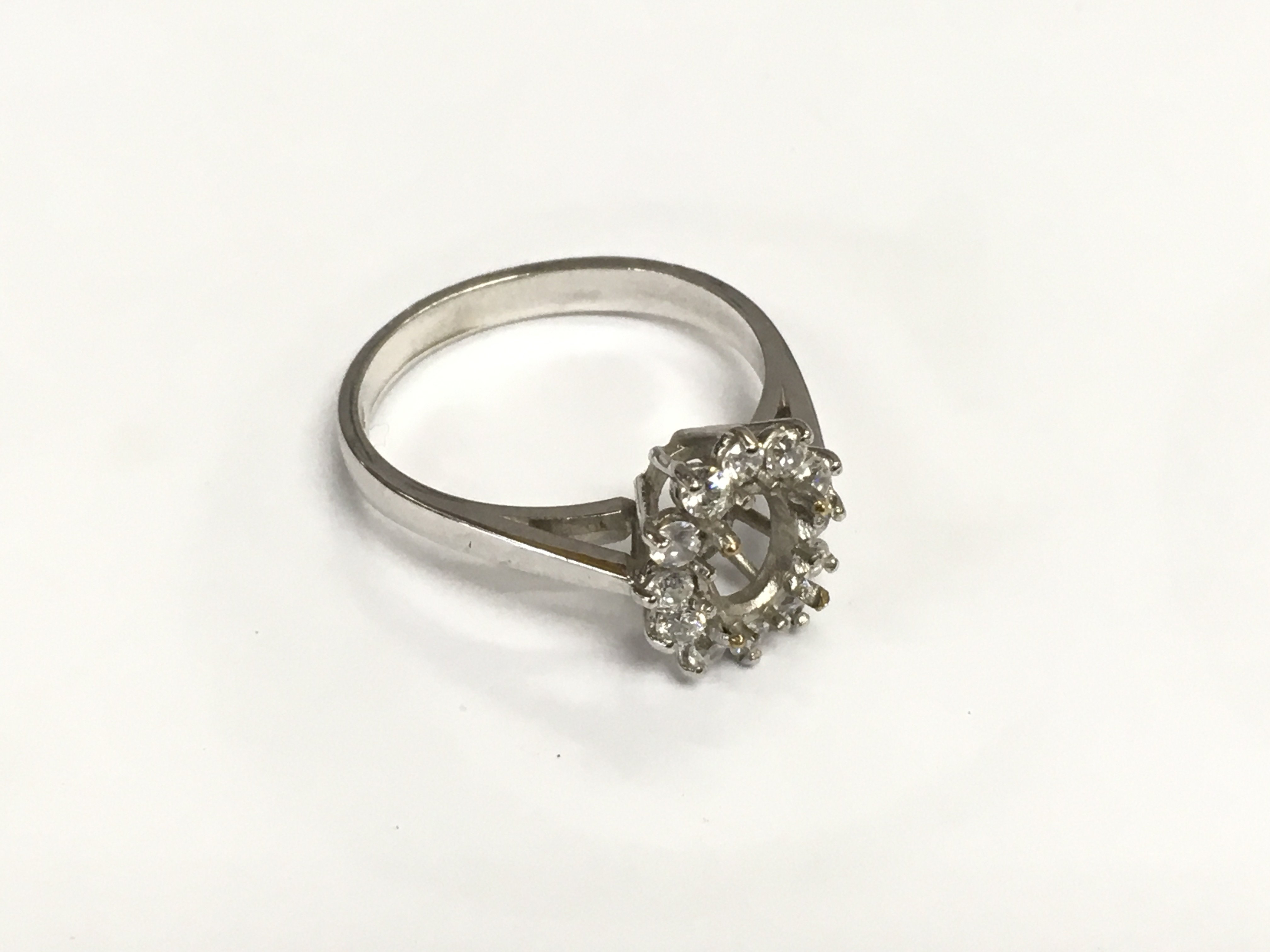 A 9ct white gold ring, no central stone, approx 2.6g and approx size M. Shipping category A.