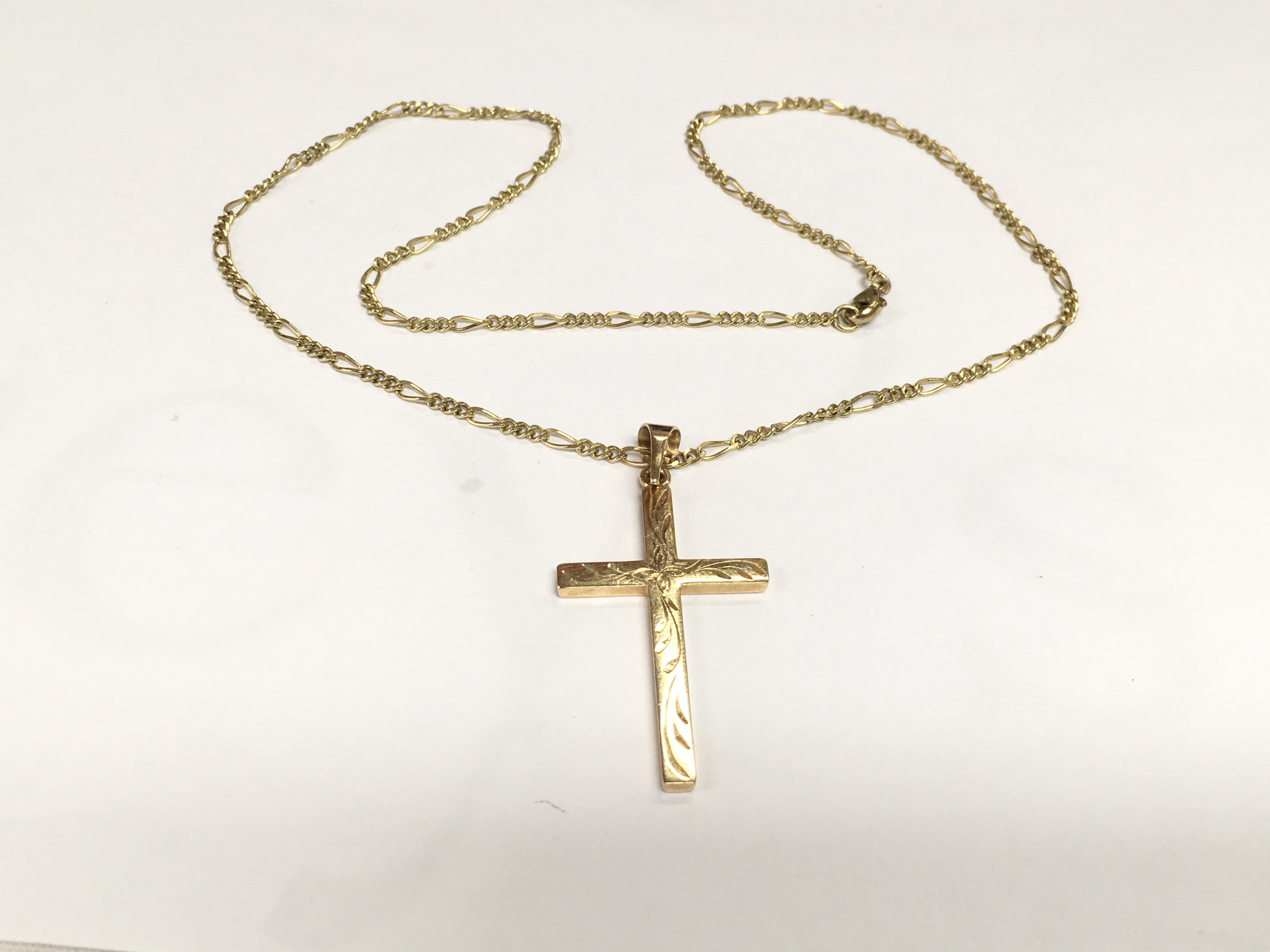 A 9ct gold cross pendant with attached chain, approx 10g. Shipping category A.
