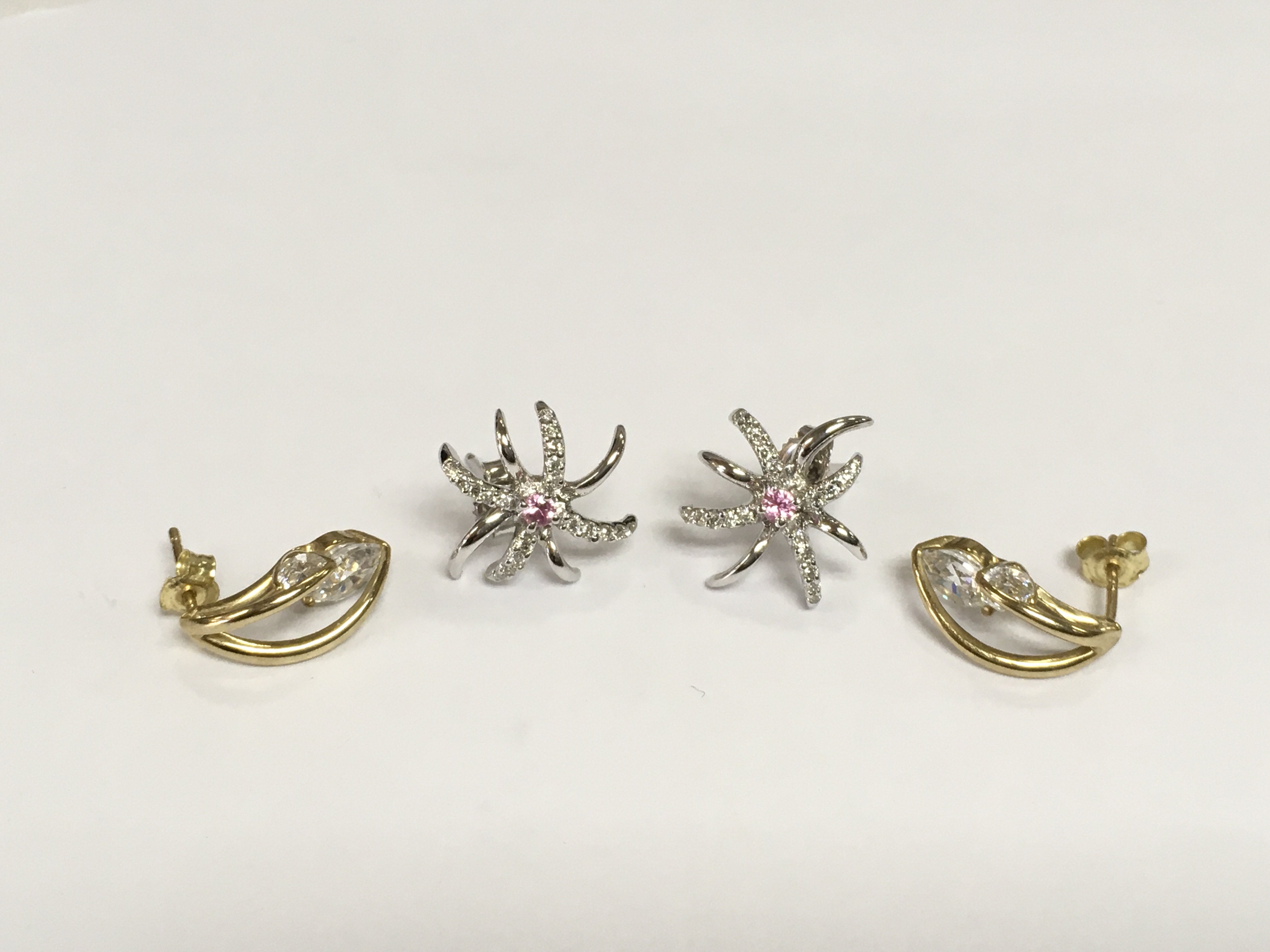 A pair of modern white gold and pink sapphire earrings and one other pair of 9ct gold earrings set with CZs, total approx 4.4g. Shipping category A.