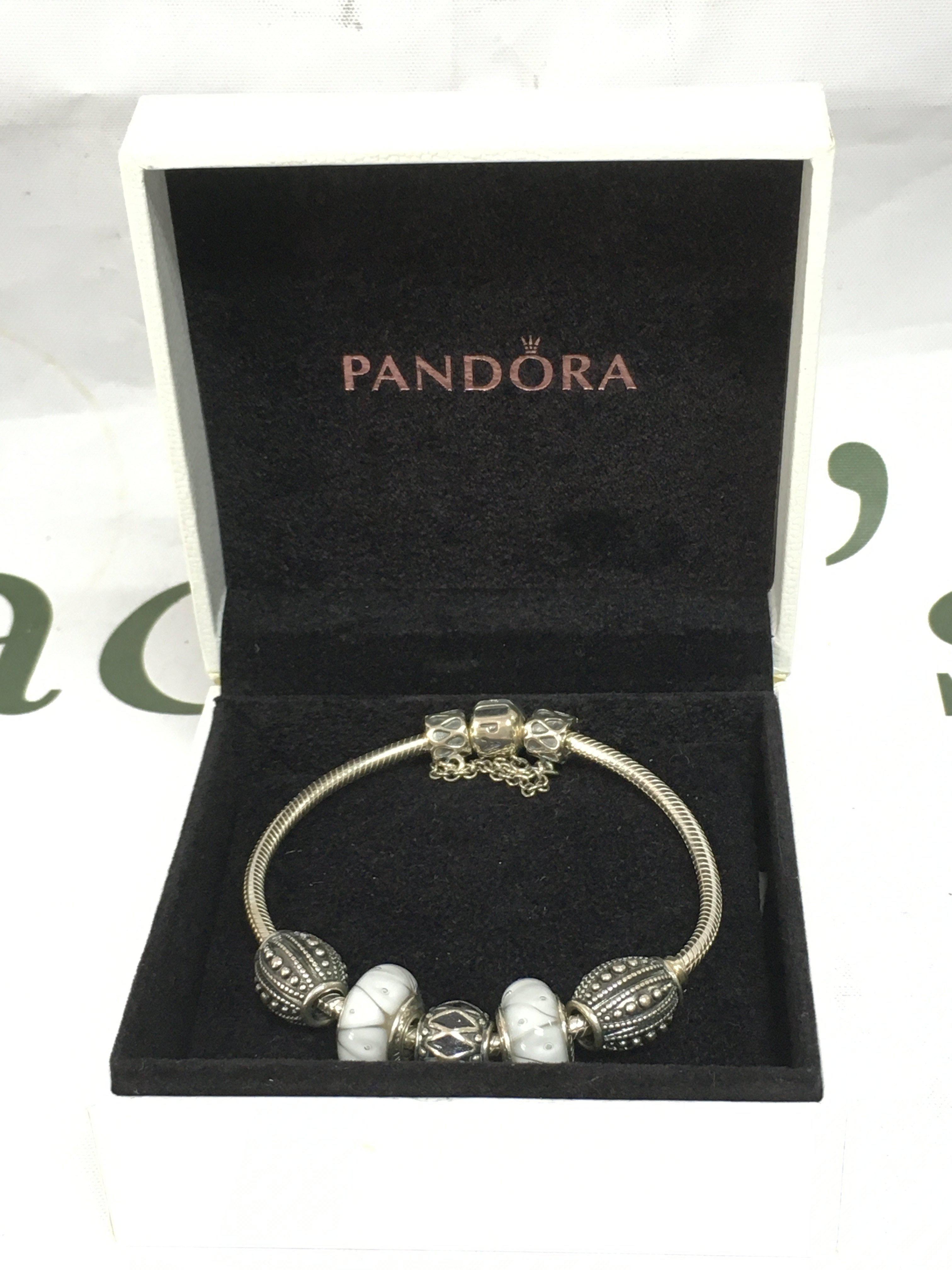 A Pandora bracelet in a fitted box. Shipping category B.