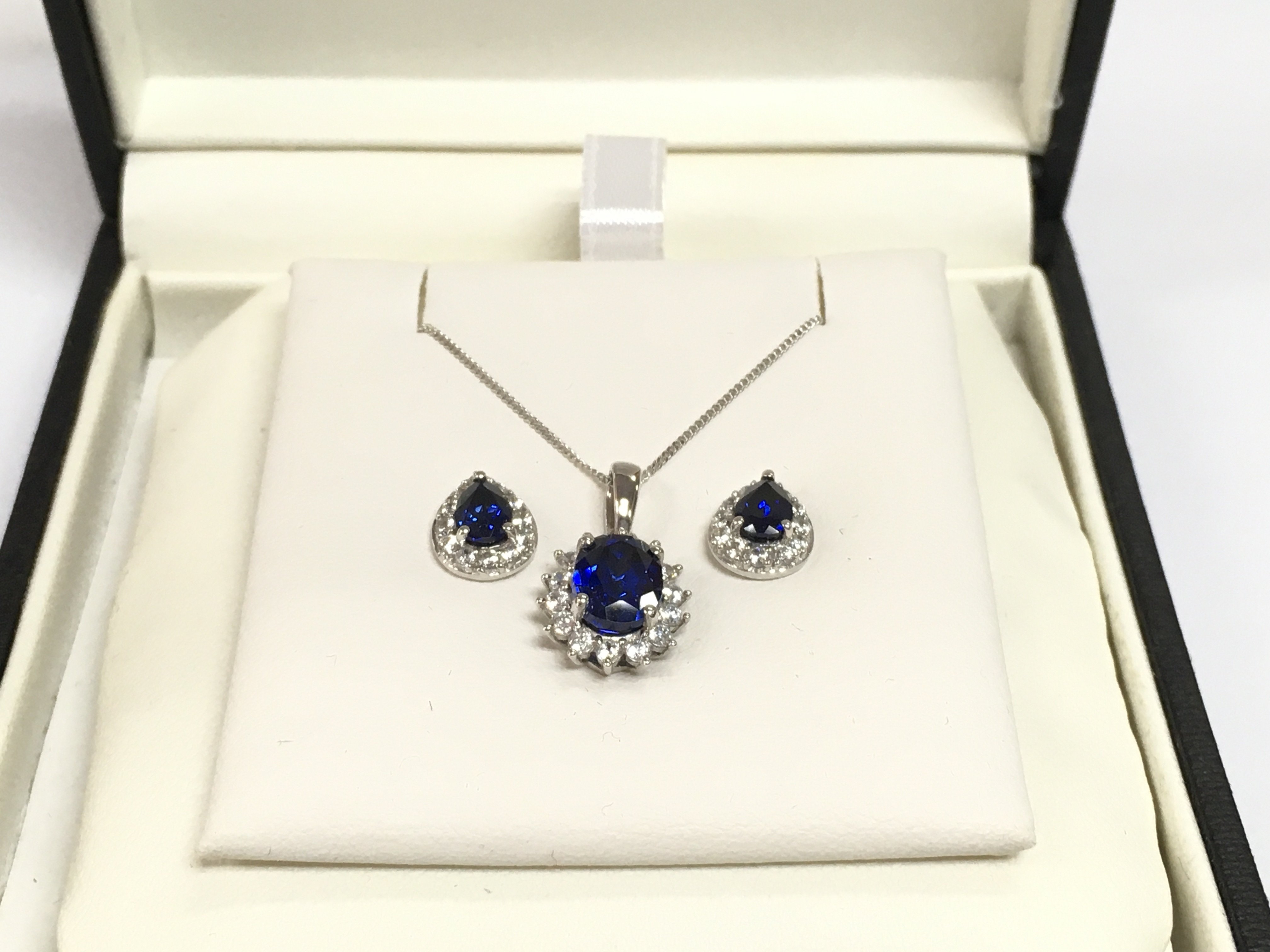 A 9ct white gold necklace and earrings set with CZs and blue simulated sapphires, total approx weight 4g. Shipping category A.
