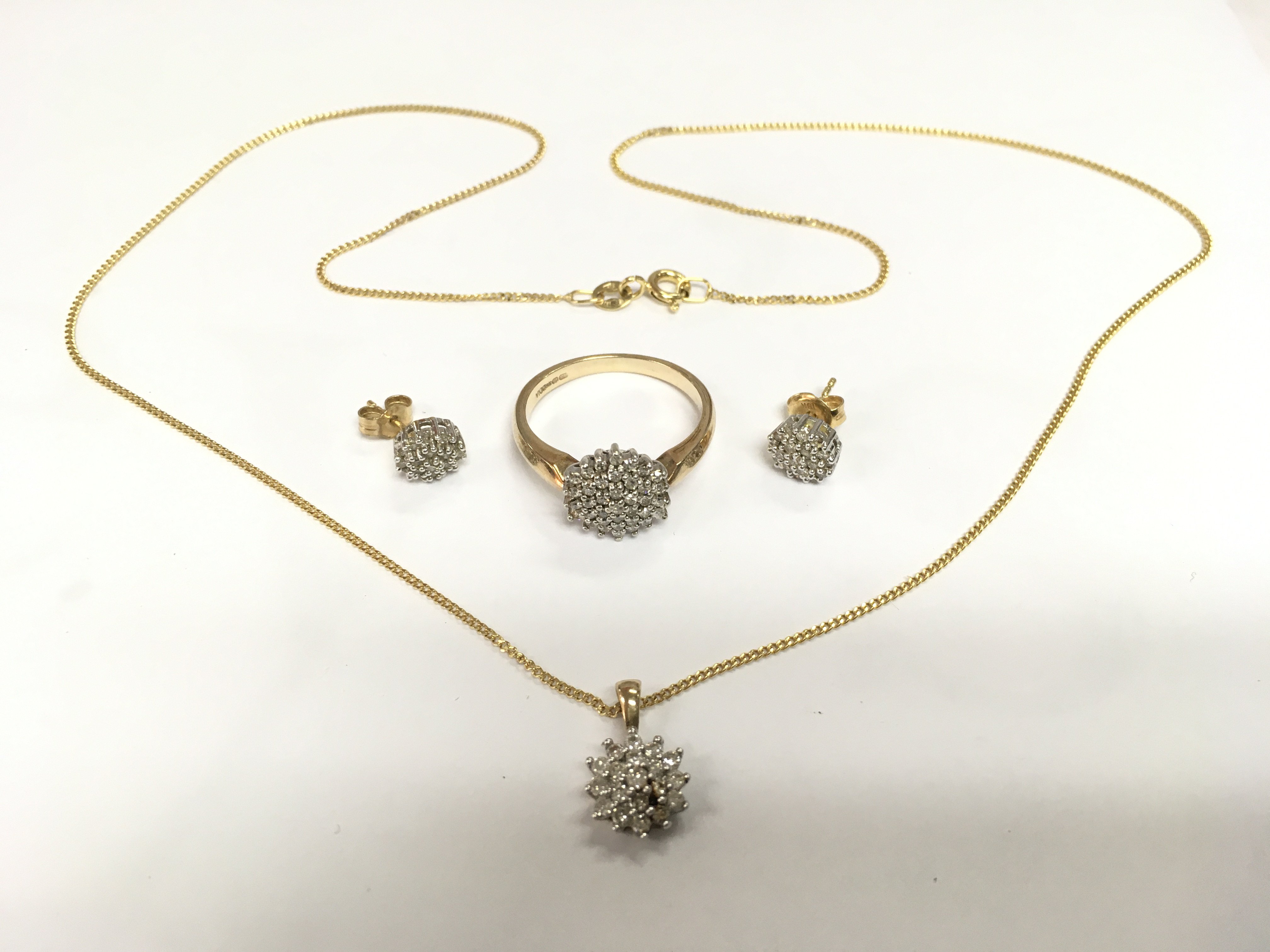 A 9ct gold chip stone diamond ring with a matching pendant and earrings, total approx weight 7g. Shipping category A.